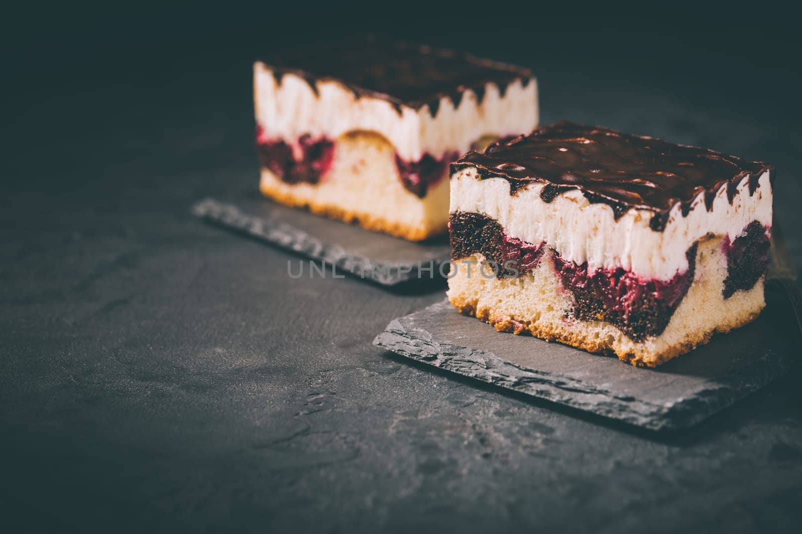 German cake Donauwelle (Danube waves) - vanilla and chocolate sponge cake with sour cherries, vanilla buttercream and chocolate icing
