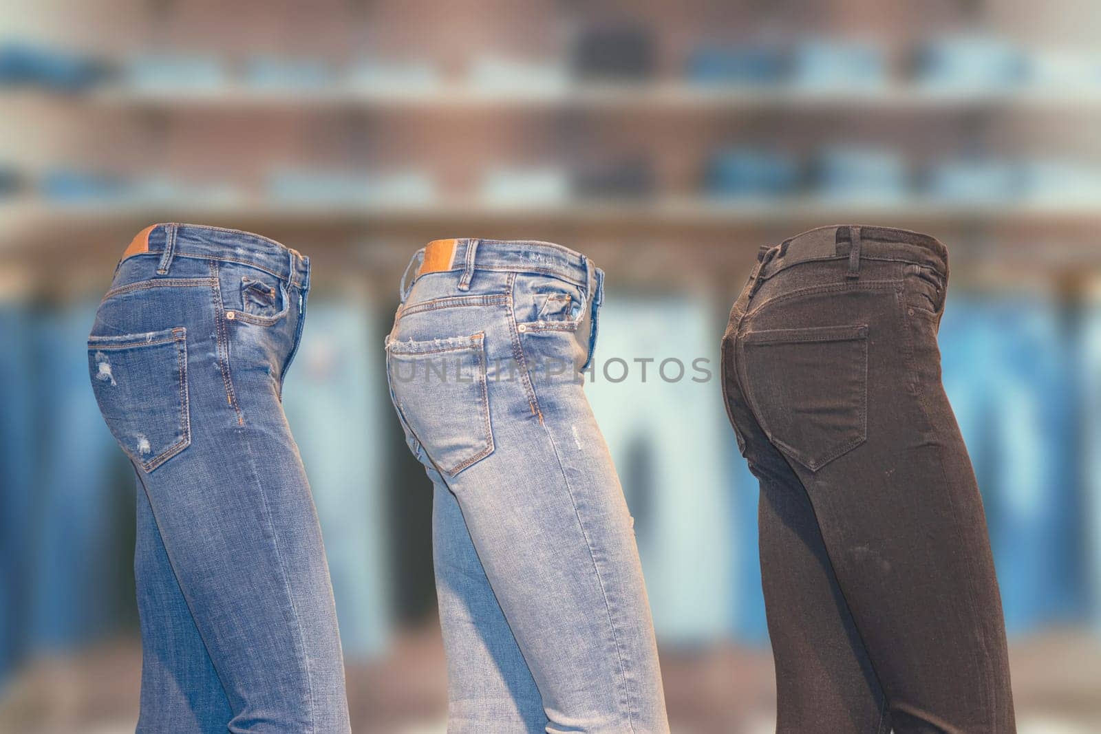 Collage set of a collection of three different denim pants on a ghost mannequin in side view over abstract blurred jeans shop. Advertisement jeans fashion. Space.