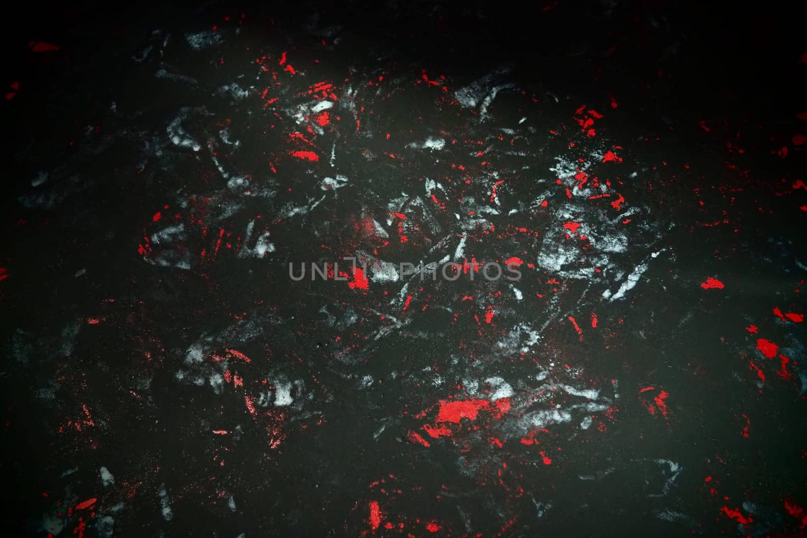 Black background with red, white, gray and blue strokes, dashes, stains and scuffs. A ray of light