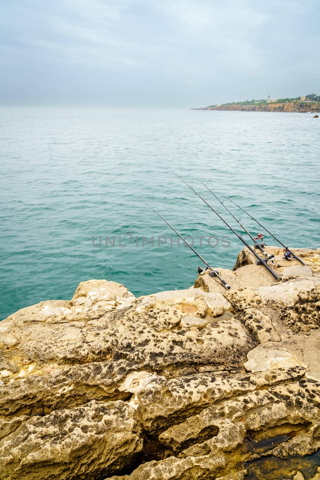 Fishing rods on the rocks of the coast of Cascais, Portugal