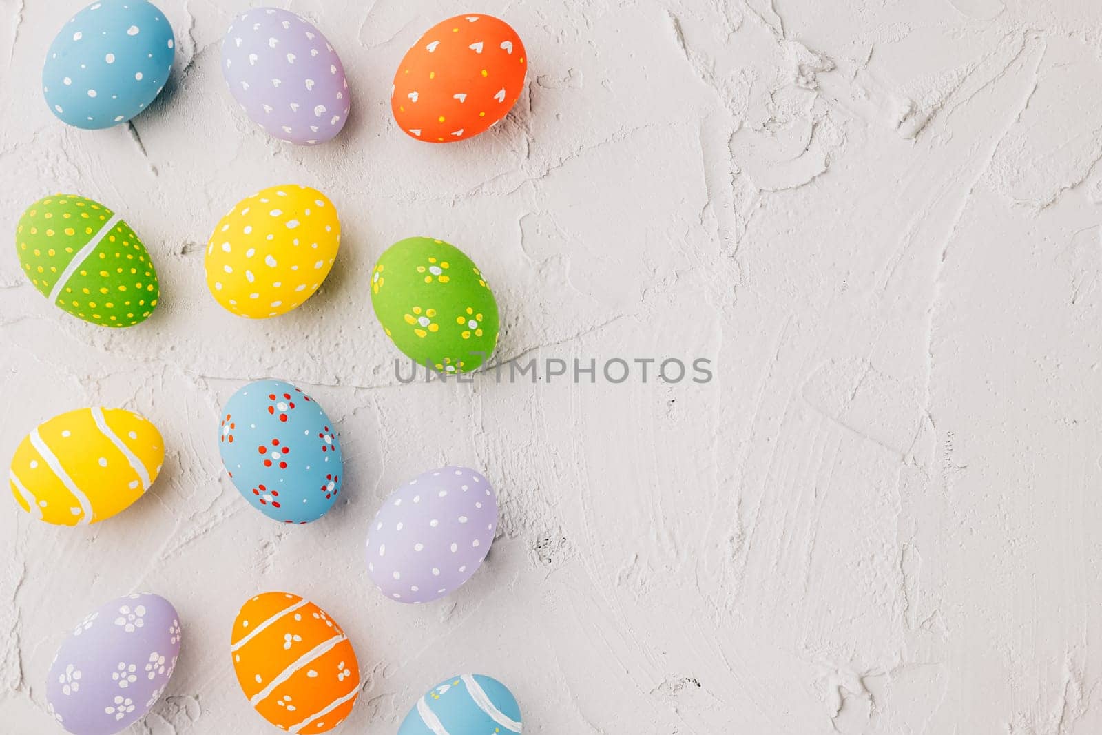 Easter Day Concept. Top view holiday banner background web design white colorful easter eggs painted on white cement background with empty copy space, celebration greeting card, overhead, template