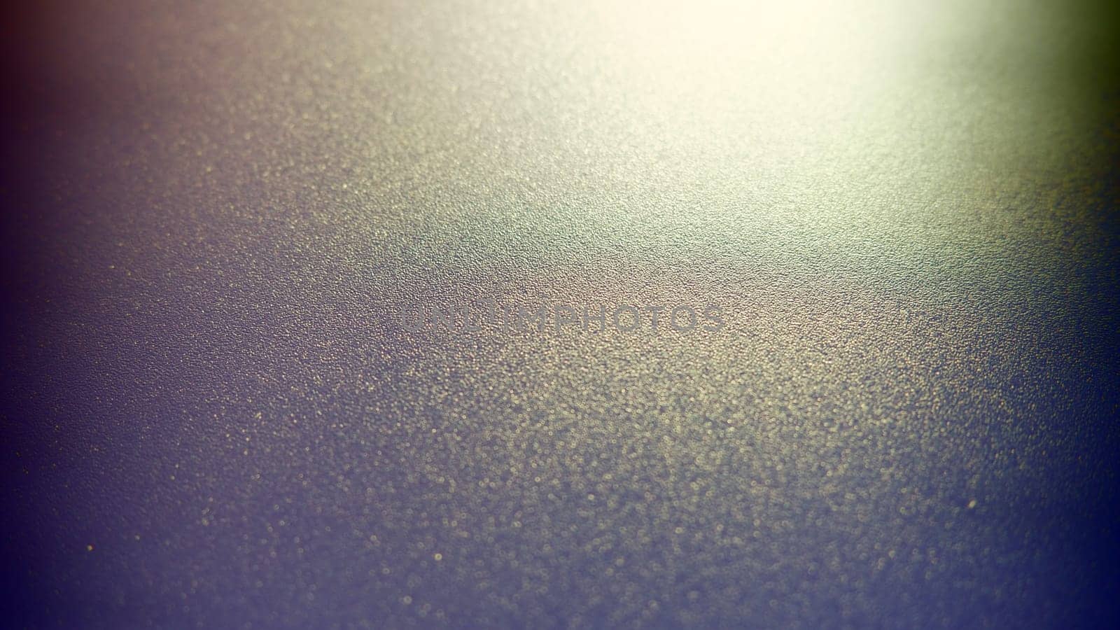 Oblique rays of light on a dark background. Blurred abstract backdrop with light effect and leaks. Side surface illumination. Divergent and asymmetric lines, stripes of light at angle. Yellowish glow.