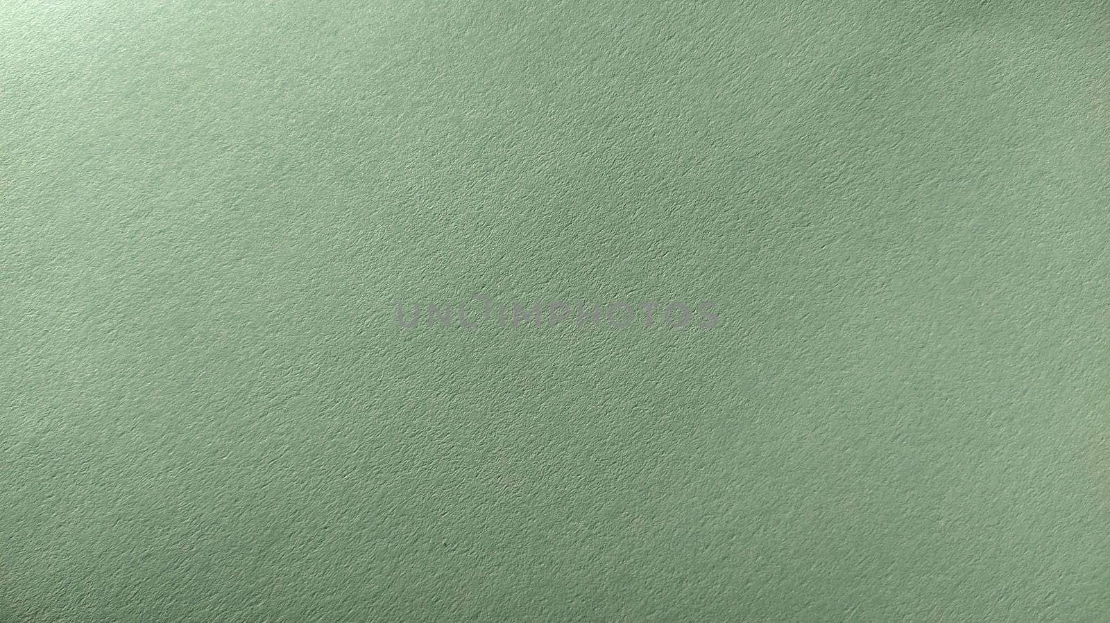 A sheet of light green paper with vignetting at the bottom. Calm green with fine paper texture. Soothing interior color.