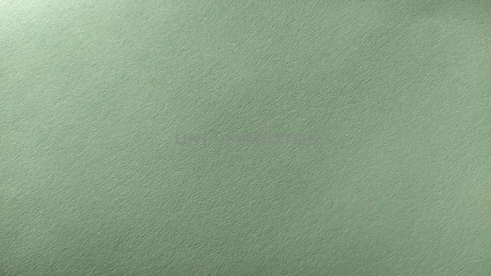 A sheet of light green paper with vignetting at the bottom. Calm green with fine paper texture. Soothing interior color.