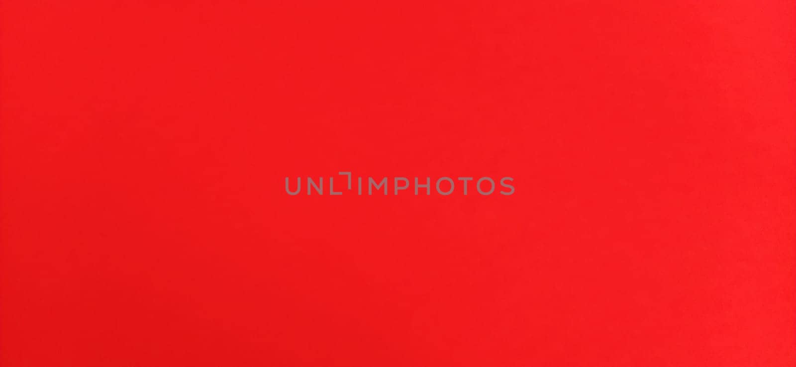 Red beautiful bright background. Scarlet uneven color. Sheet of colored paper.