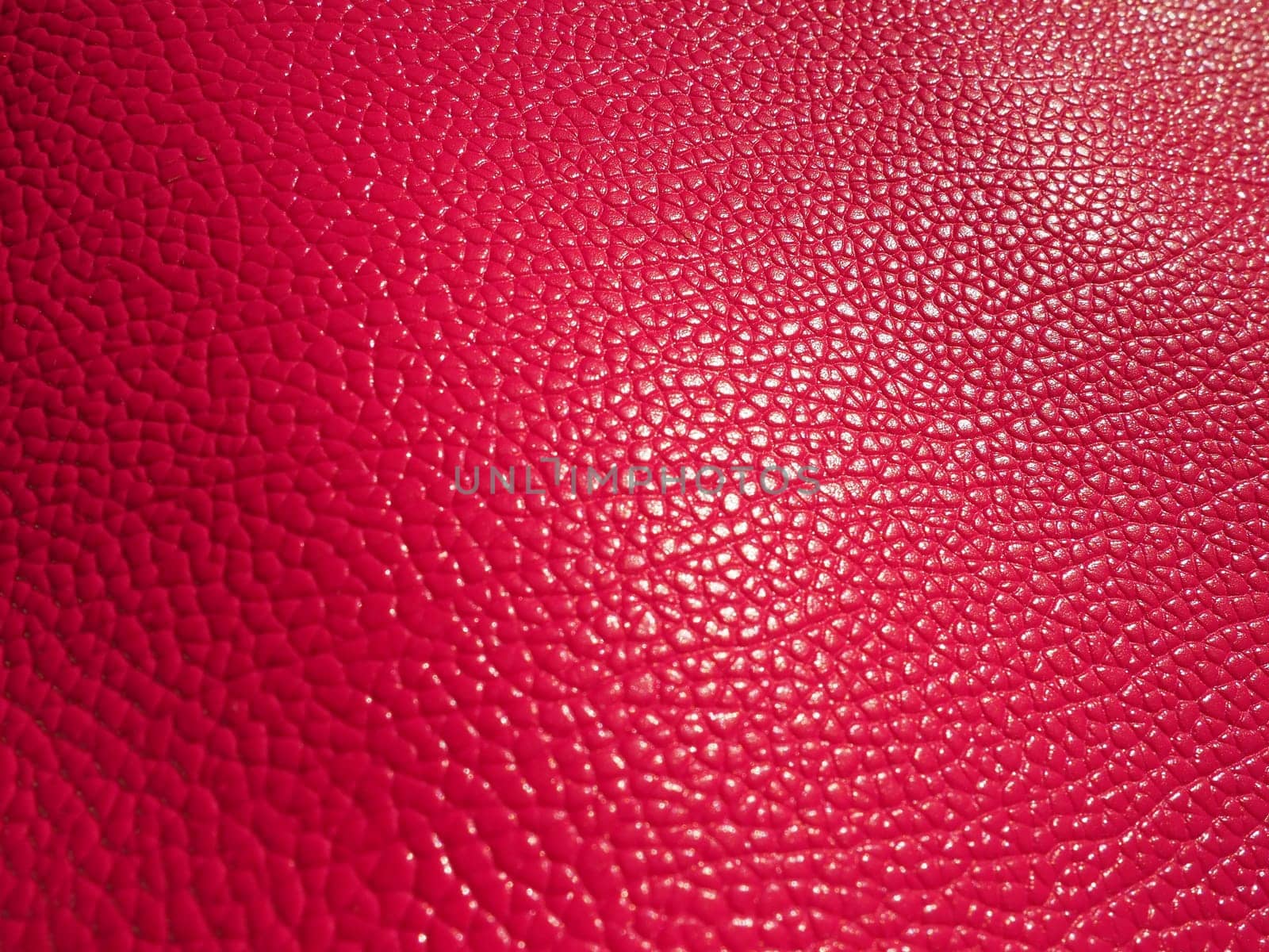Red or pink leather. Material for fashion accessories, for sewing leather and suede products, furniture upholstery. Natural leather texture. Magenta or fuchsia.