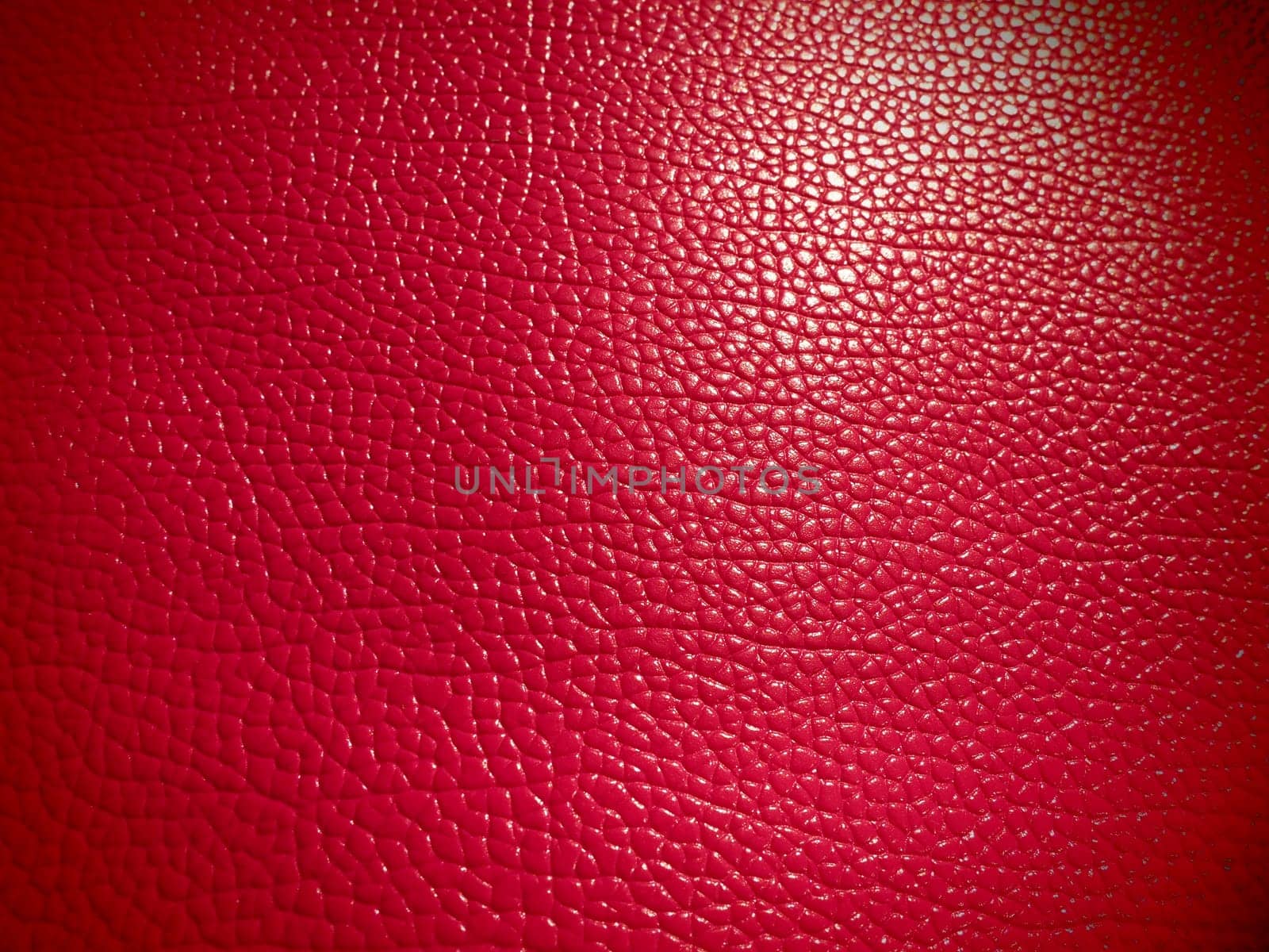 Red or pink leather. Material for fashion accessories, for sewing leather and suede products, furniture upholstery. Natural leather texture. Magenta or fuchsia.