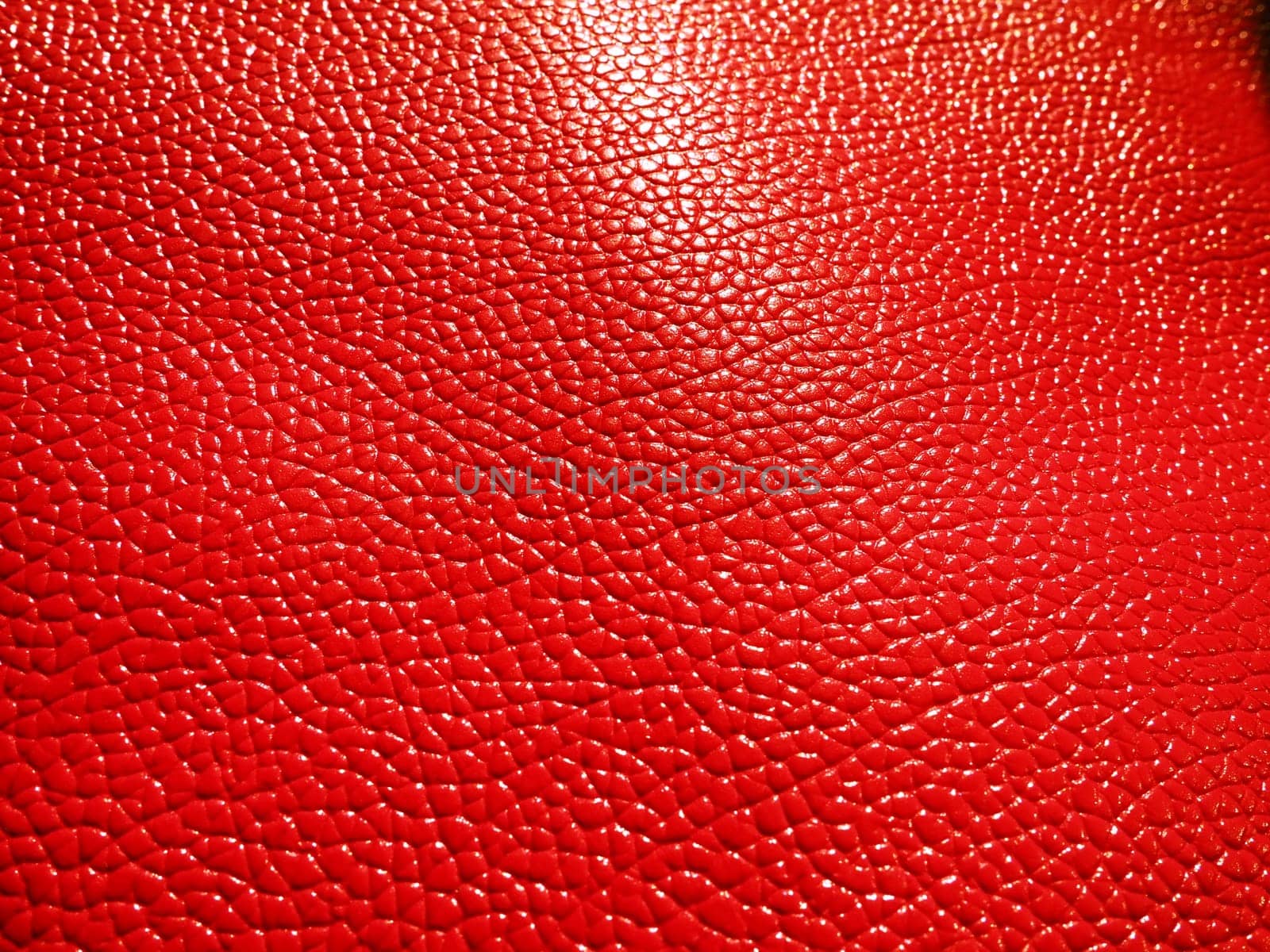 Red or pink leather. Material for fashion accessories, for sewing leather and suede products, furniture upholstery. Natural leather texture. Magenta or fuchsia