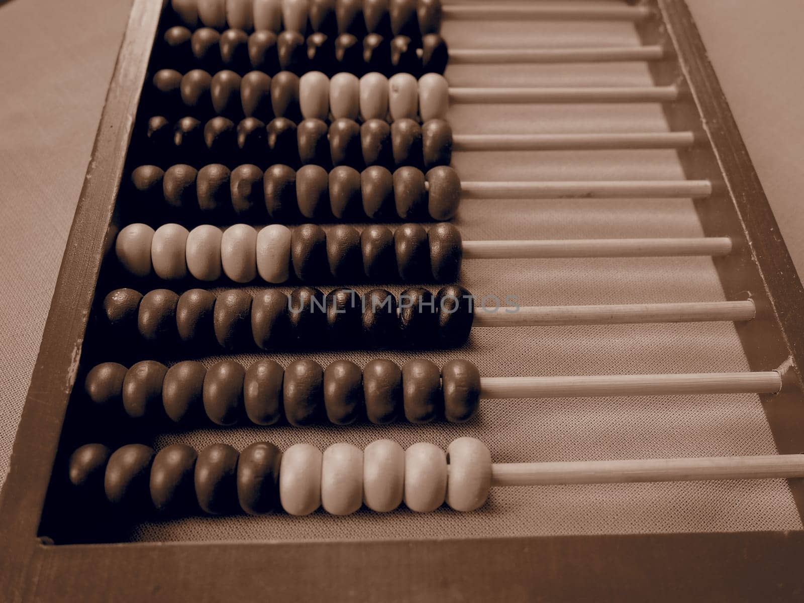 Education concept - abacus with many colorful beads. Red, blue, green, black, yellow details on the abacus. Mathematical exercises. School program.