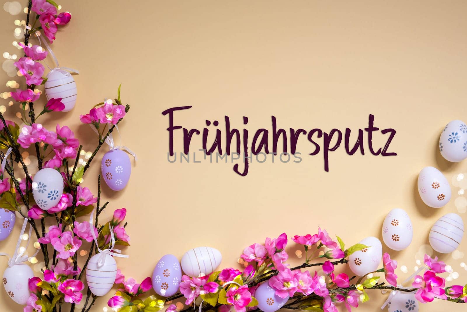 German Text Fruehjahrsputz Means Spring Cleaning On Beige Background. Pink And Purple, Shiny And Bright Spring Flower Arrangement With Easter Egg Decoration.