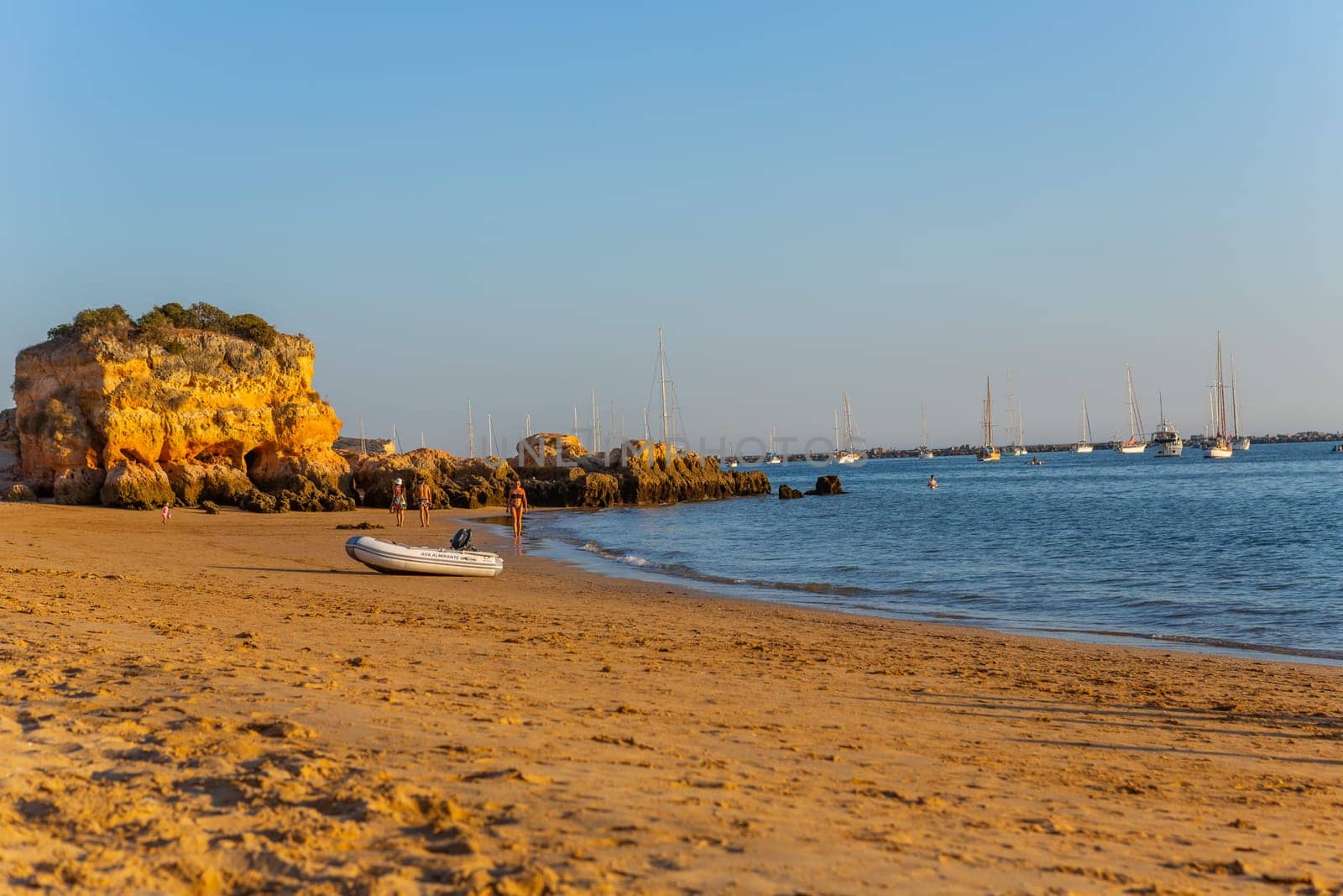 Ferragudo, Portugal - 25 August 2025: Beautiful seascape with beach, cave and ocean. Praia Grande beach. Ferragudo, Lagoa, Algarve, Portugal