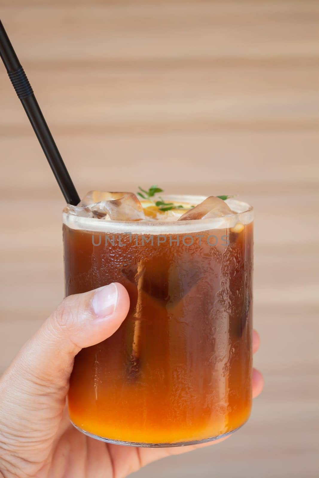 Iced coffee with orange in coffee shop, stock photo
