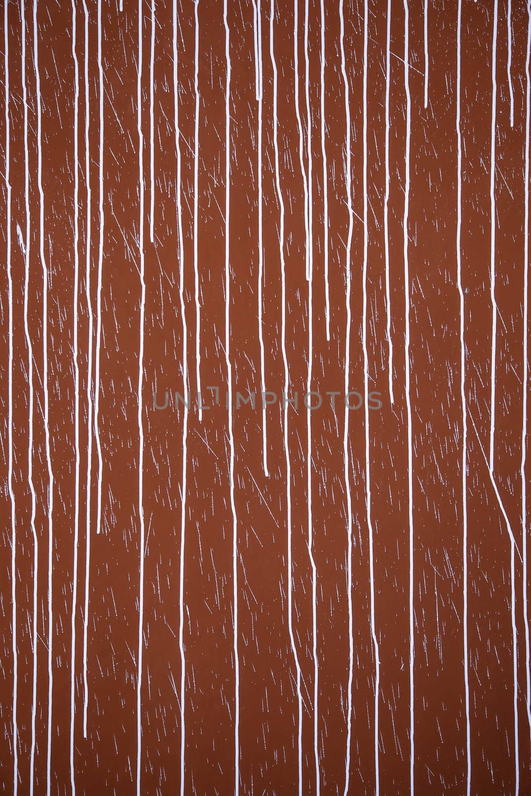 Detail of red wall damaged by vandalism and crime