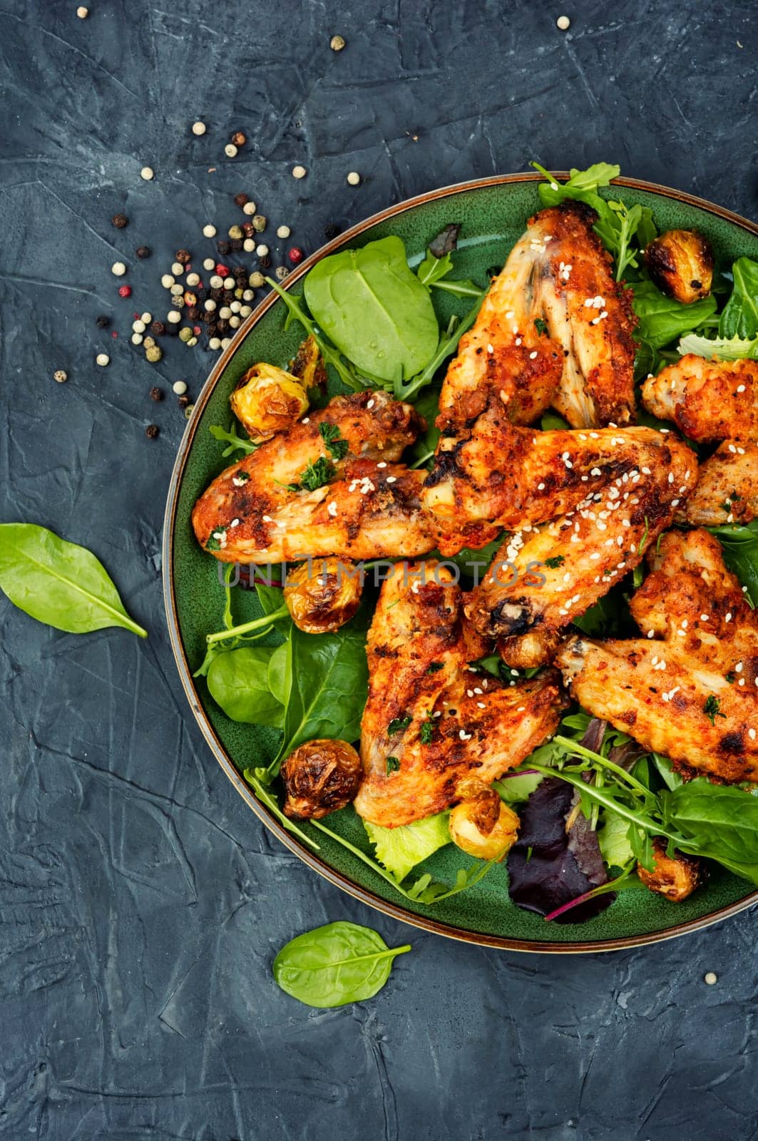 Baked chicken wings with vegetables. Poultry meat