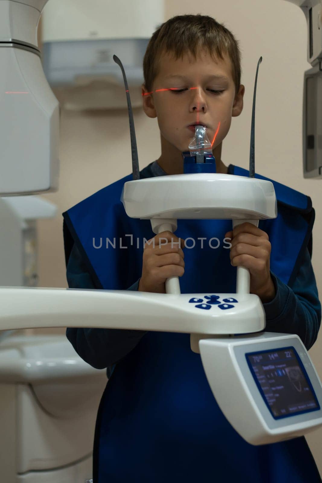 Jaw computed tomography, check up teeth in dental clinic. Little boy on x-ray diagnostics. Circular snapshot of jaw on modern medical equipment. CT scanning, stomatology and radiology.