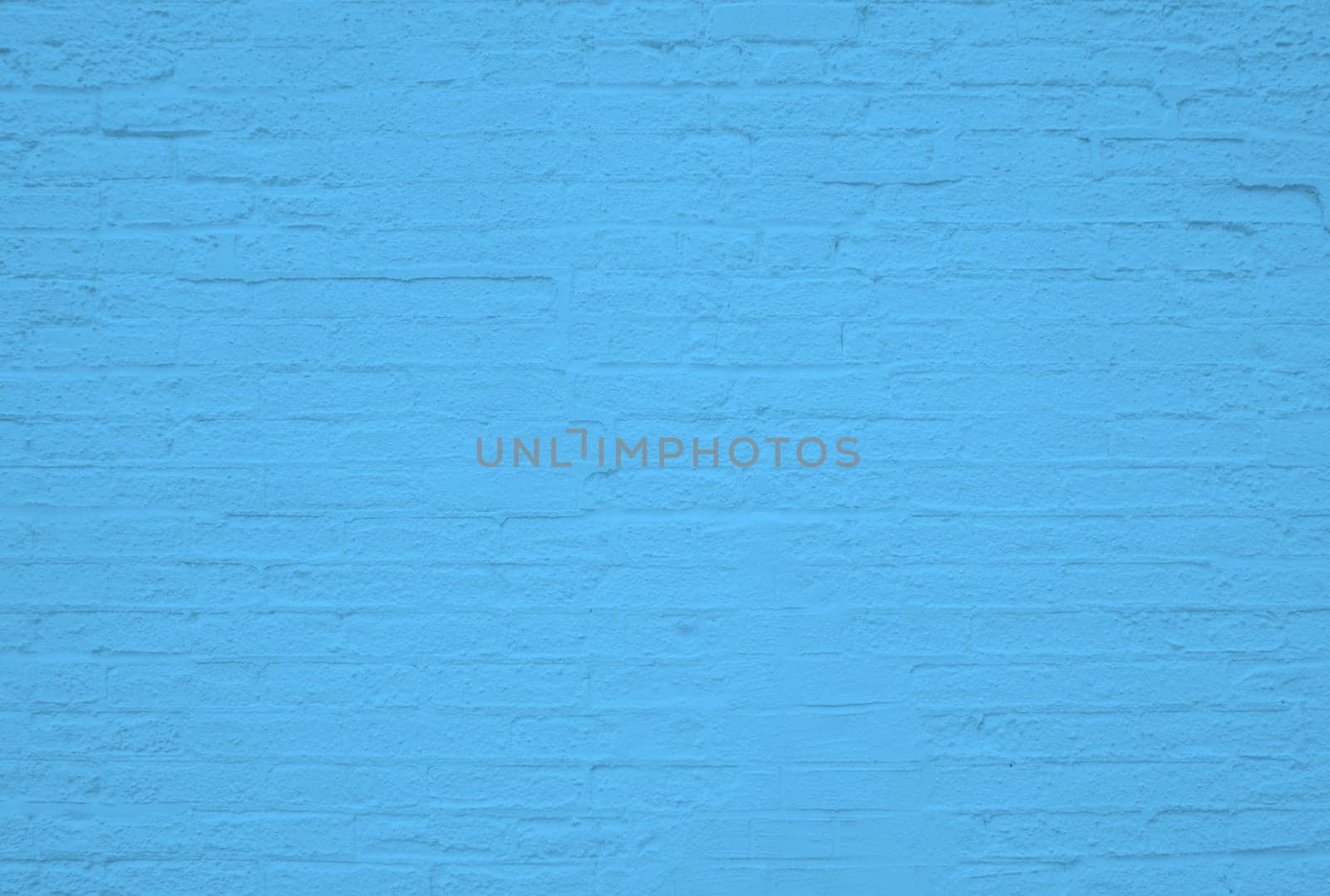 Old weathered brick wall background texture with blue color