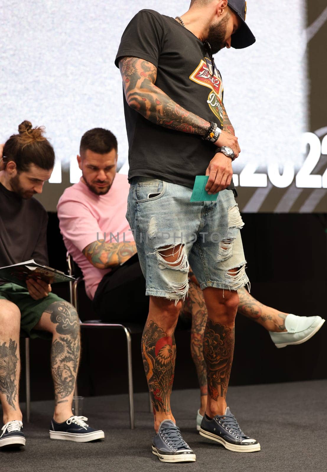 Krakow, Poland - June 11, 2022: Unidentified participant during the contest for the best tattoo at the 15th Tattoofest Convention in Cracow. One of the most prestigious tattoo festivals.
