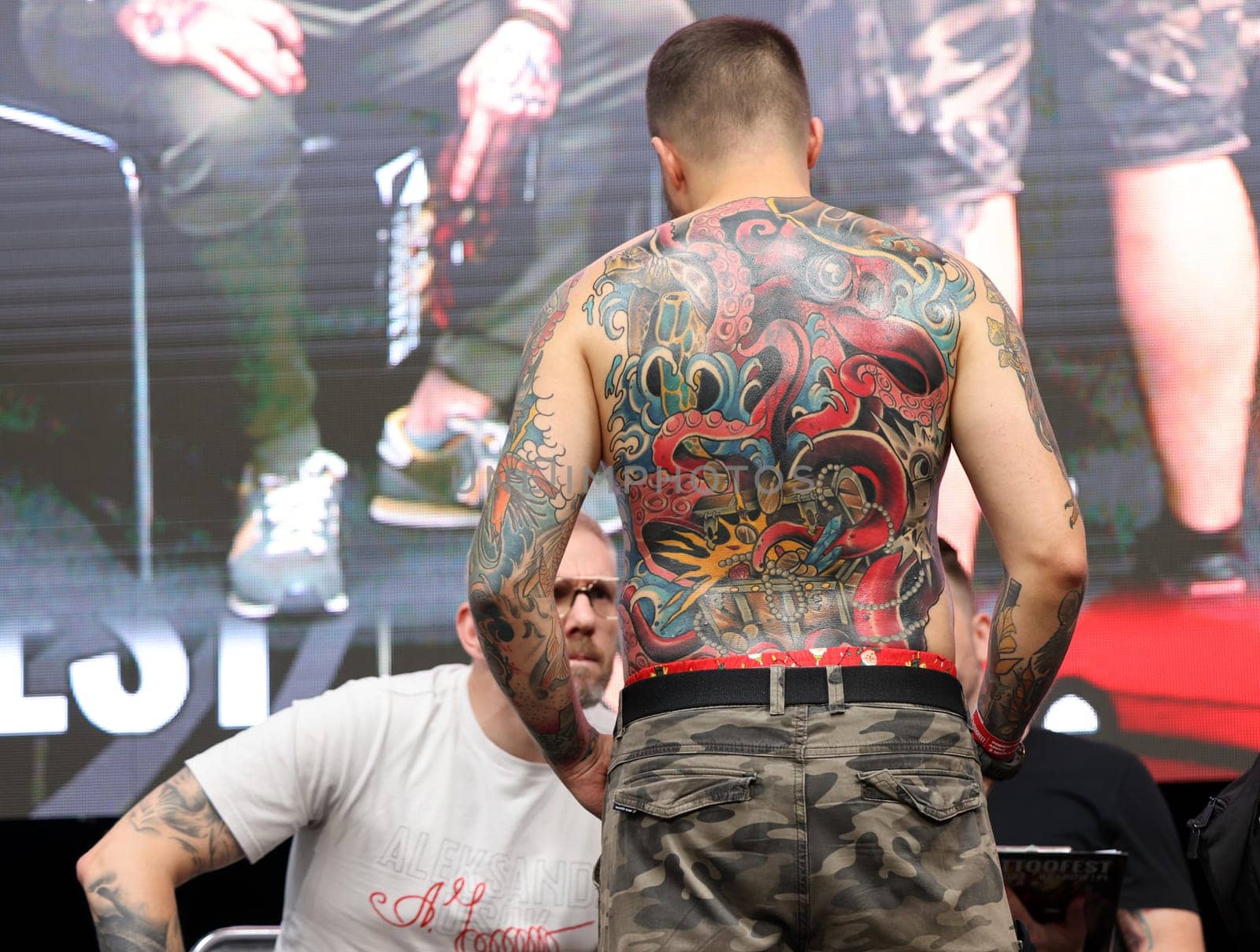 Krakow, Poland - June 11, 2022: Unidentified participant during the contest for the best tattoo at the 15th Tattoofest Convention in Cracow. One of the most prestigious tattoo festivals.