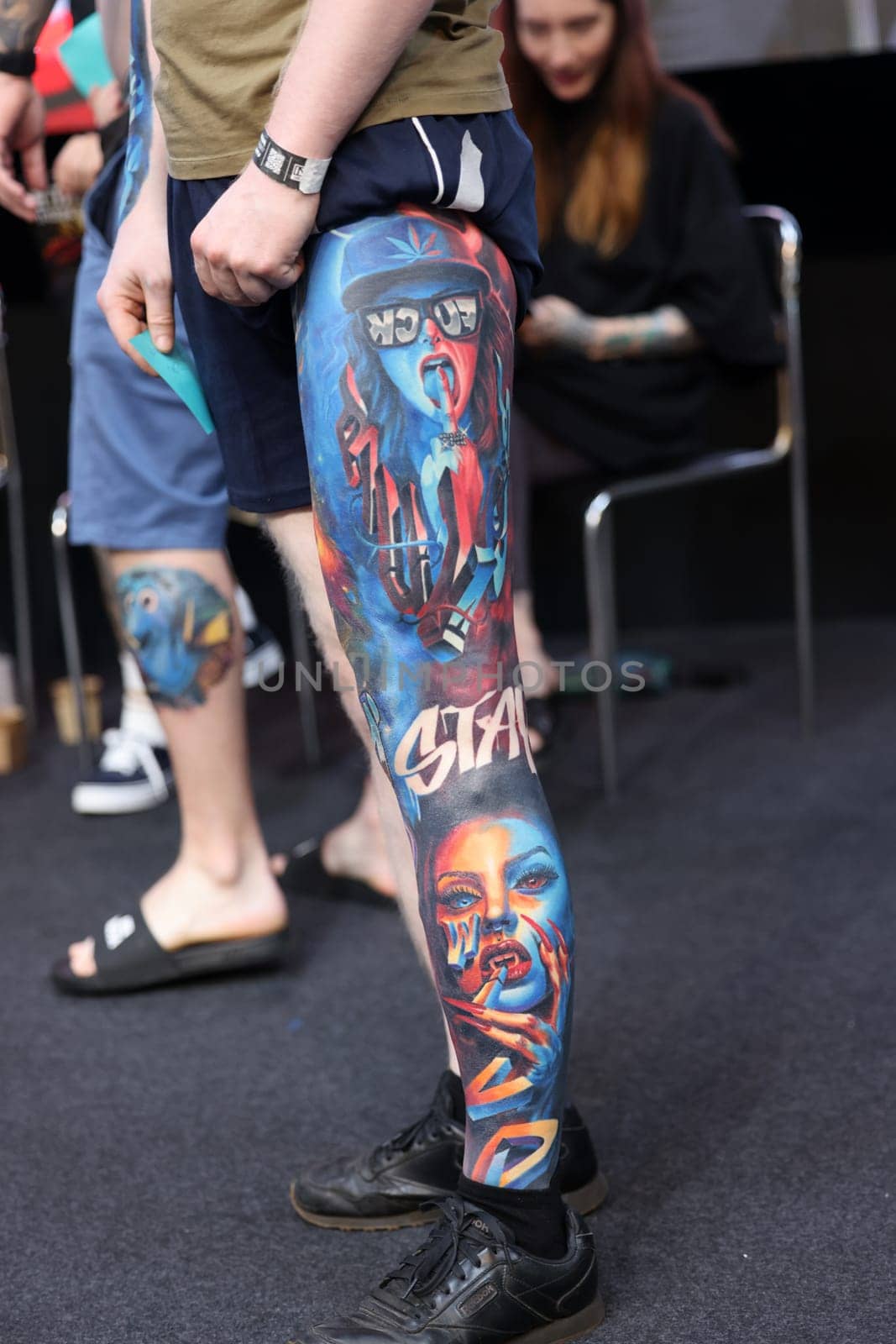 Krakow, Poland - June 12, 2022: Unidentified participant during the contest for the best tattoo at the 15th Tattoofest Convention in Cracow. One of the most prestigious tattoo festivals.