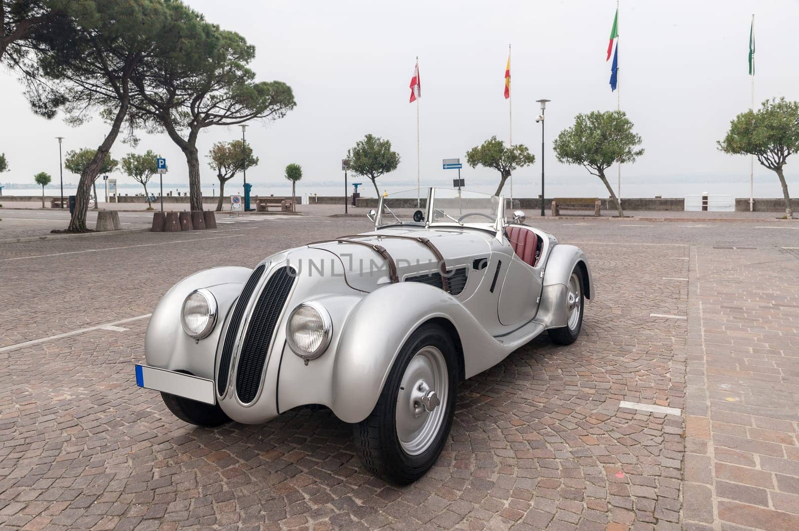SIRMIONE, Province of Brescia,  ITALY - MAY 08 unidentified crew on an old car BMW 328 coupe  1938 in italian historical rally Mille Miglia 2014, on May 08, 2014 in  Lake Garda town of Sirmione, Italy