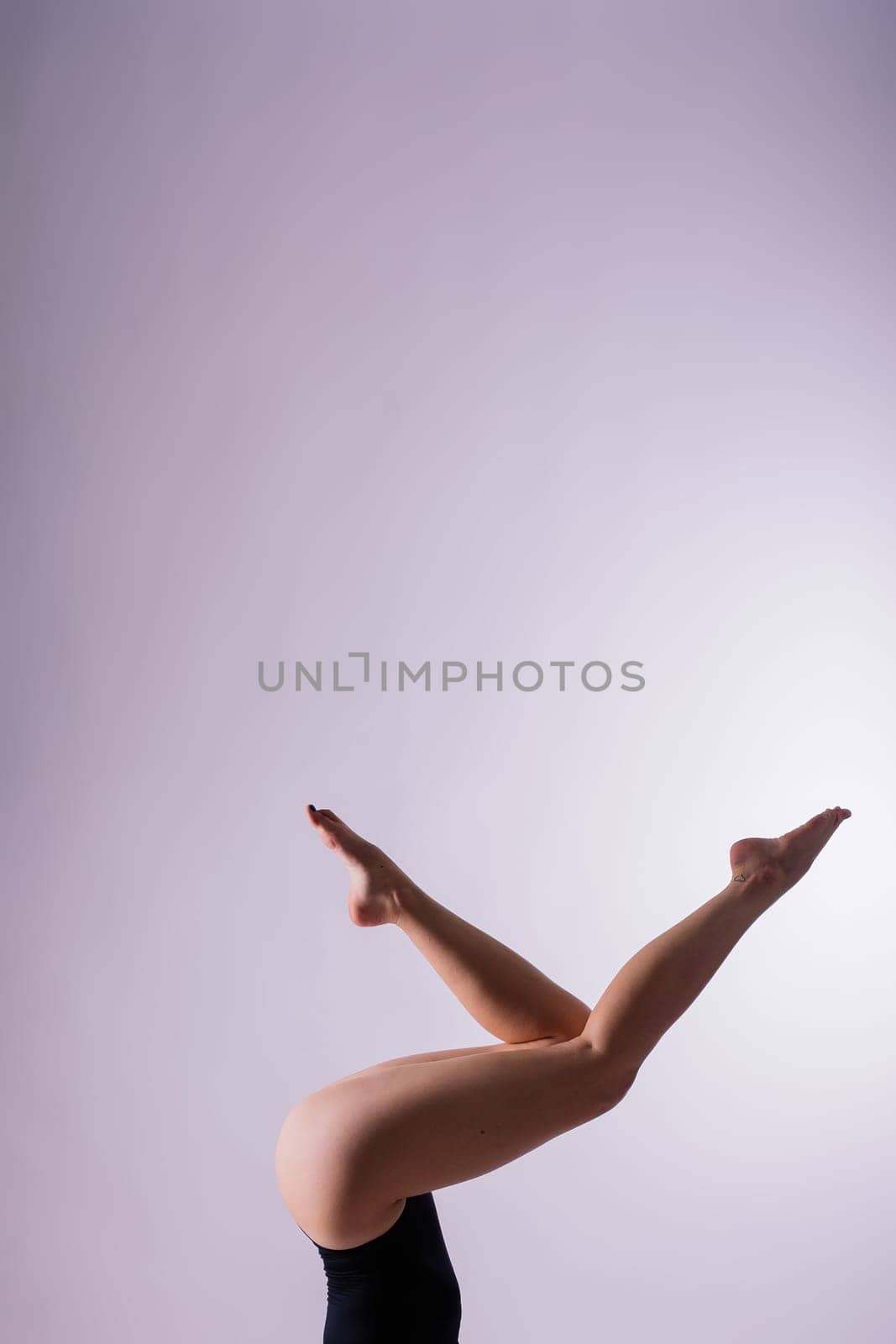 Image of a young plump female doing acrobatic stunt, studio shot