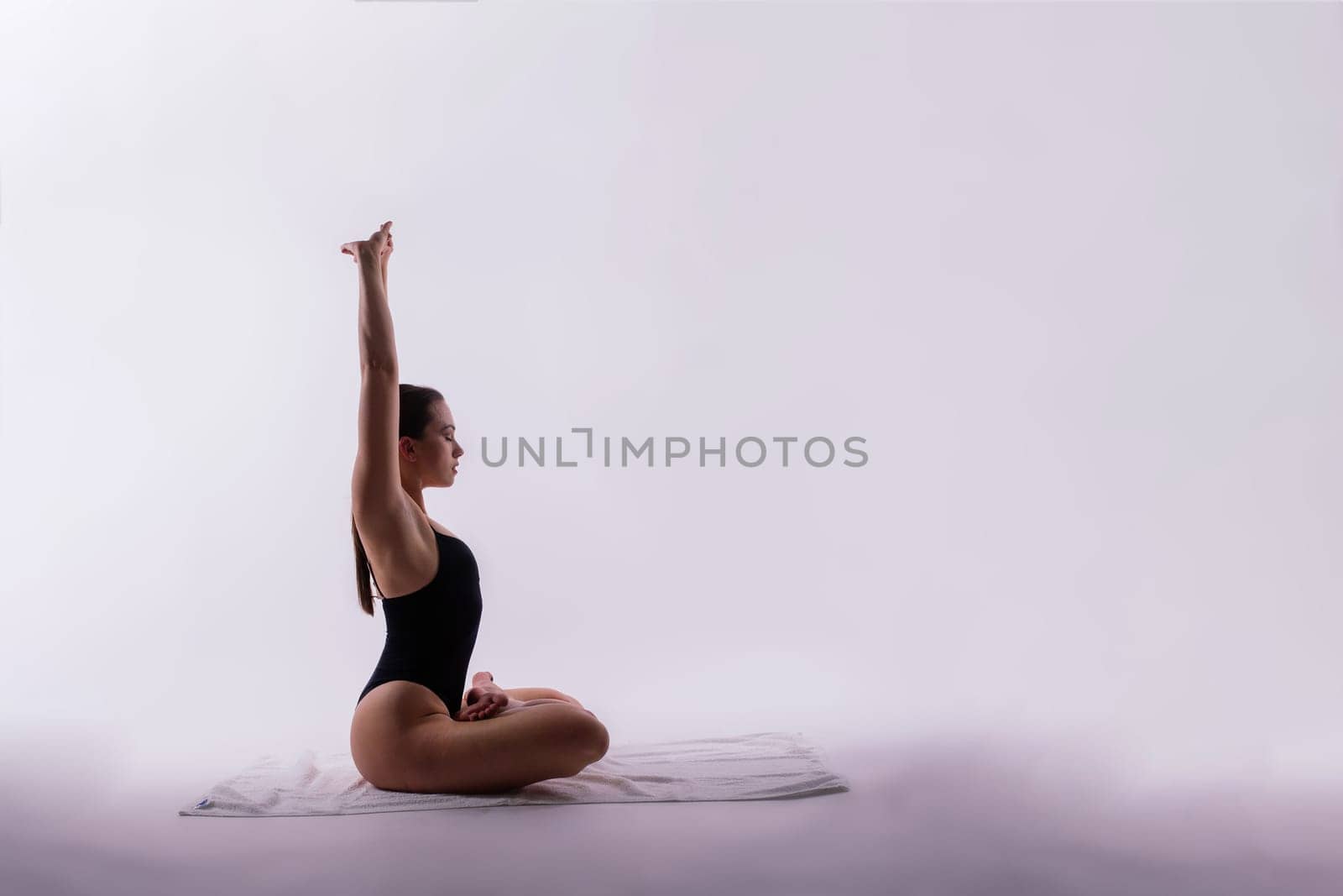 Image of a young plump female doing acrobatic stunt, studio shot