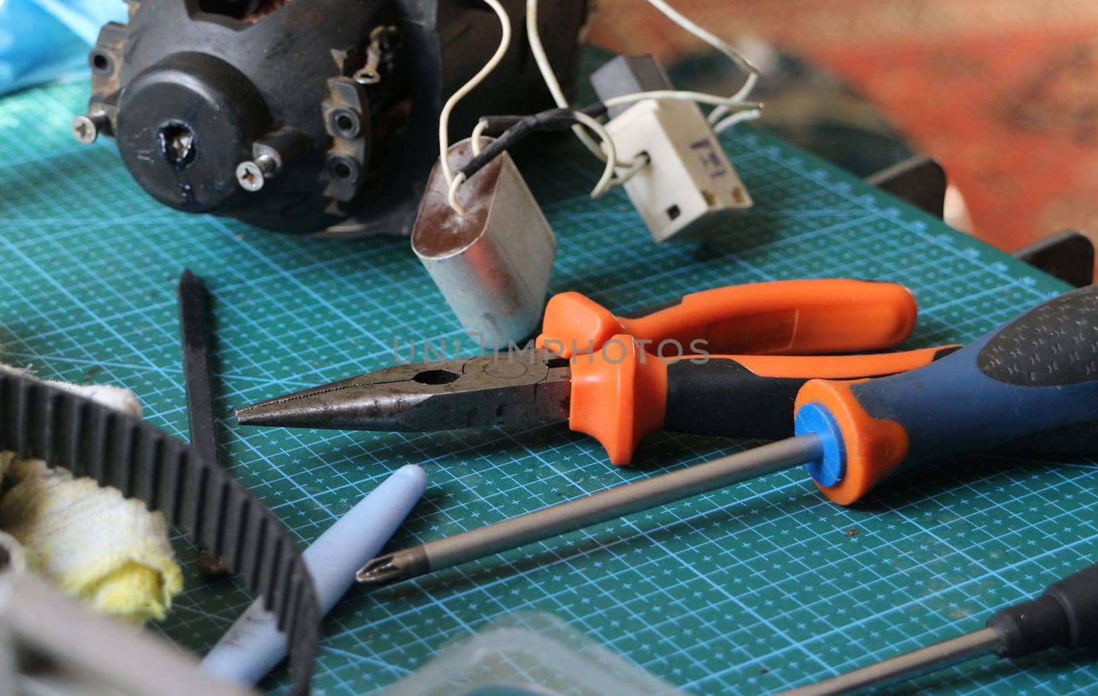 pliers, screwdriver tool on desktop in repair shop