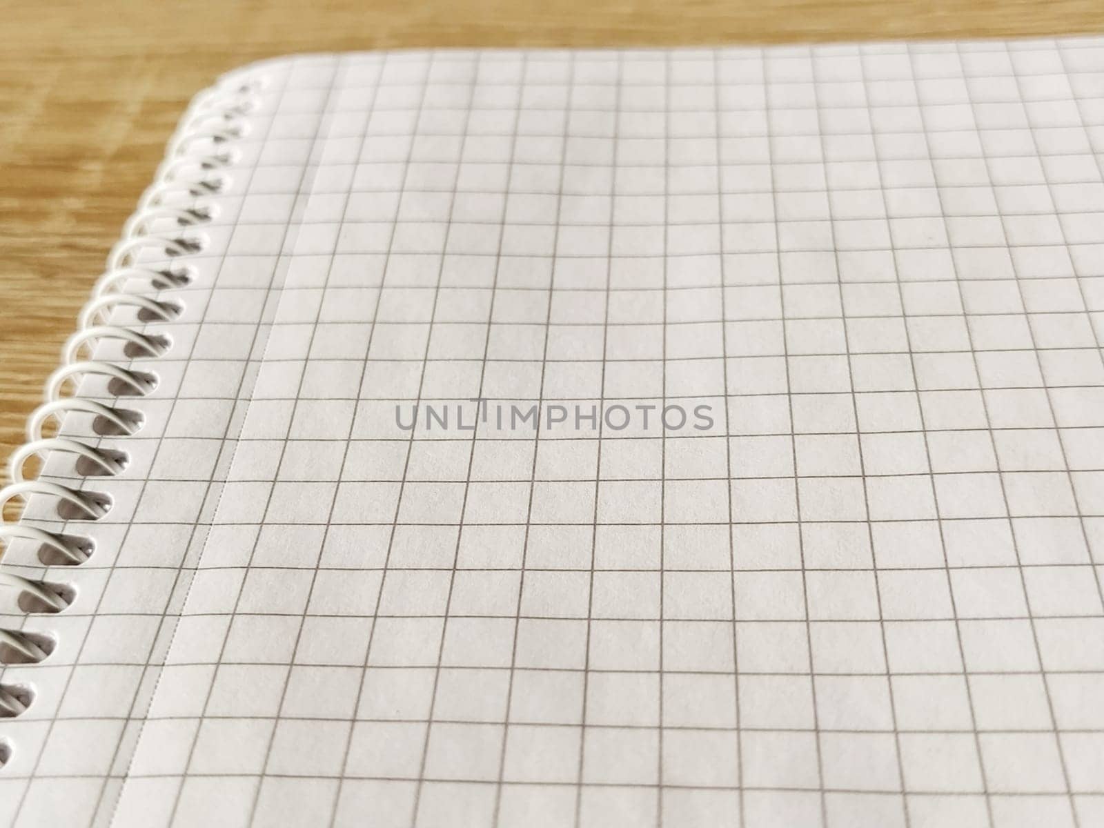 Checkered notebook with spiral. An open notepad for notes. Soft focus. Copy space. Blank blank page for your text.