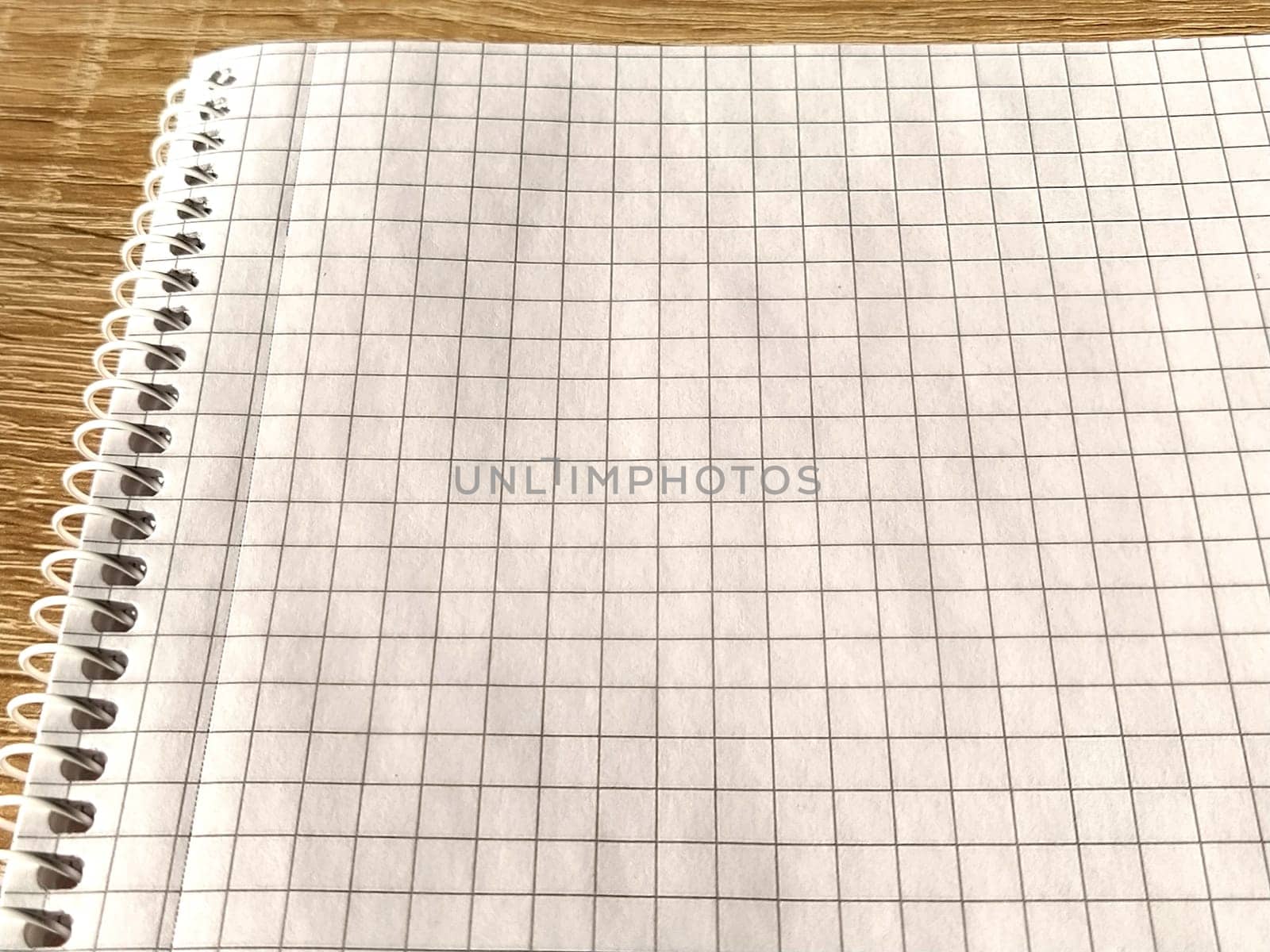 Checkered notebook with spiral. An open notepad for notes. Soft focus. Copy space. Blank blank page for your text.