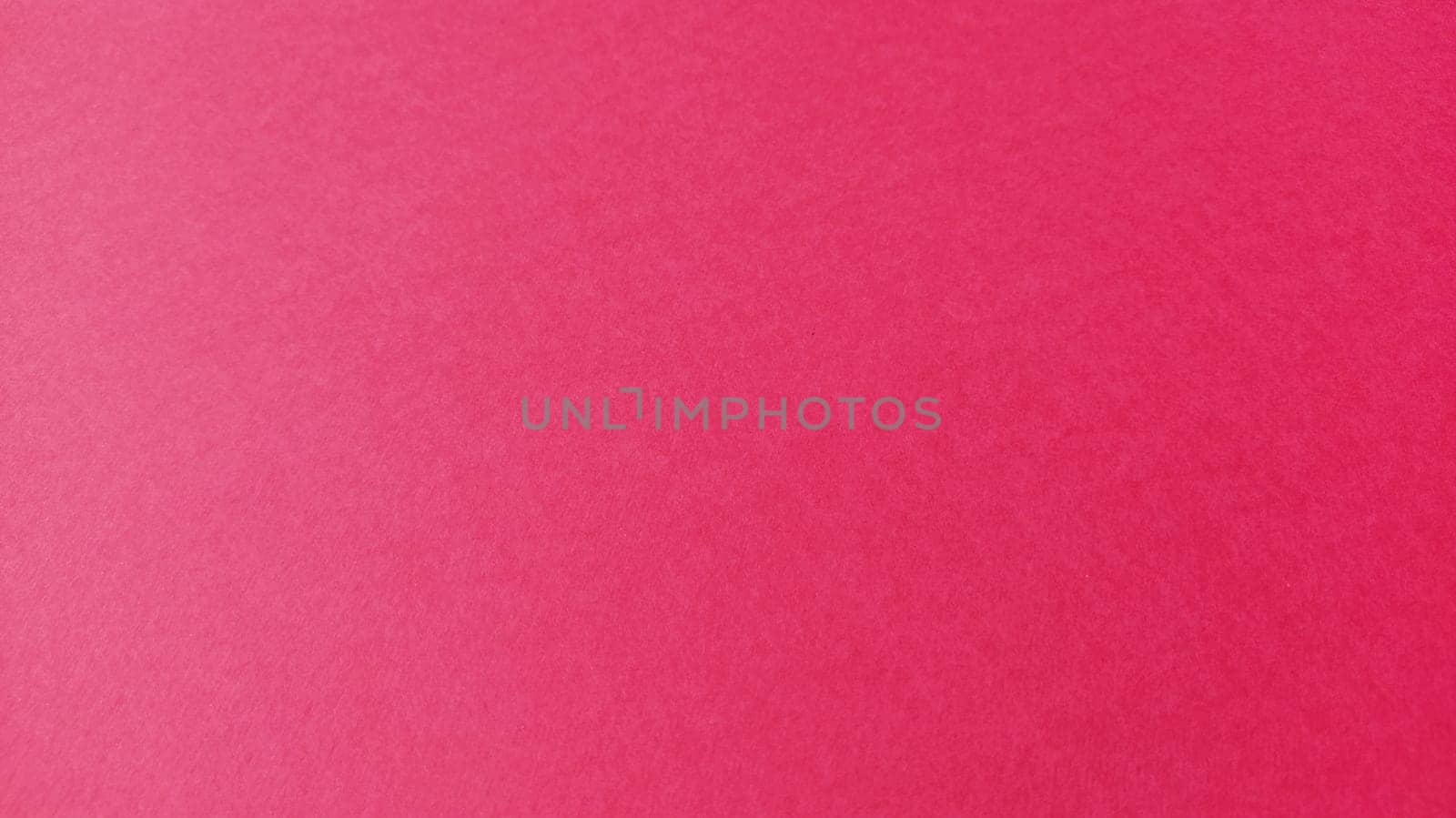 Beautiful pink or fuchsia bright background. Scarlet, purple, uneven color. A sheet of colored paper with a soft fleecy texture.