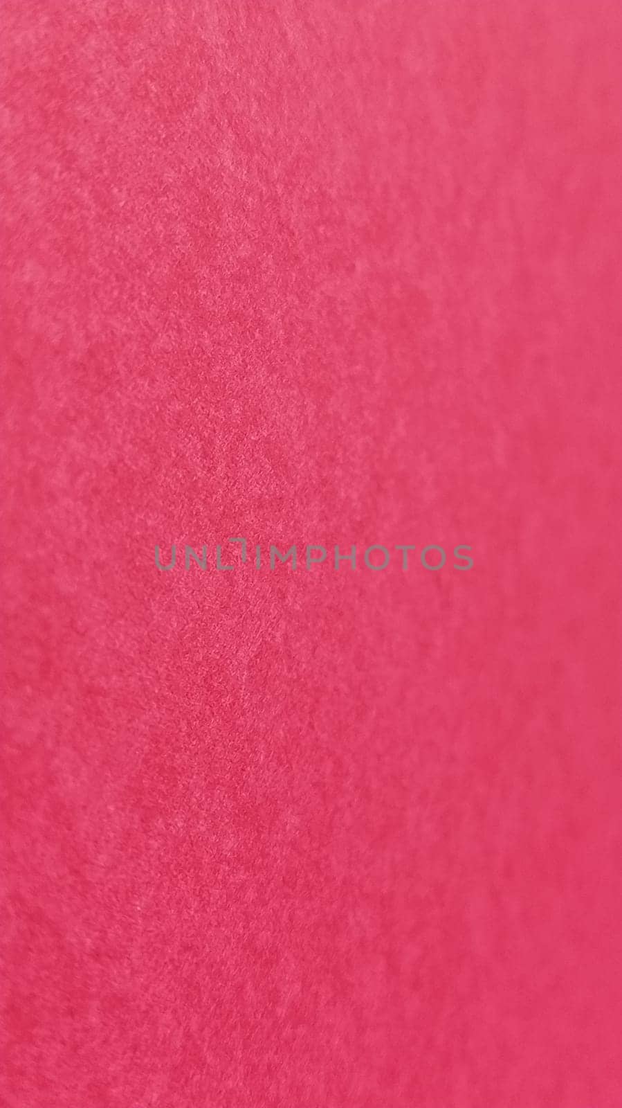 Beautiful pink or fuchsia bright background. Scarlet, purple, uneven color. A sheet of colored paper with a soft fleecy texture