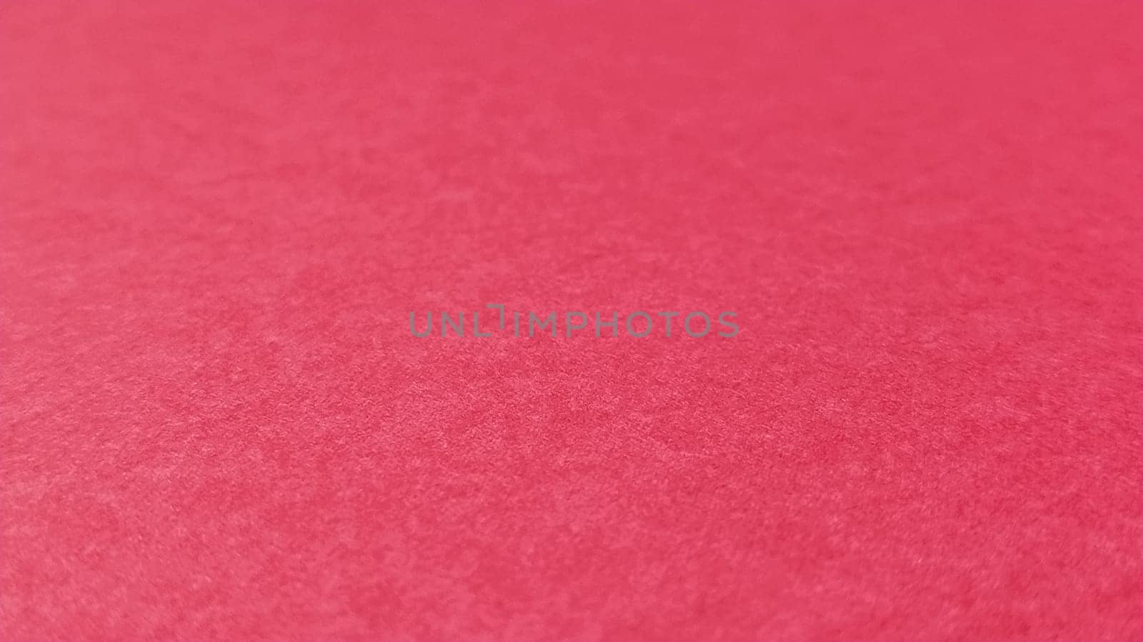 Beautiful pink or fuchsia bright background. Scarlet, purple, uneven color. A sheet of colored paper with a soft fleecy texture.