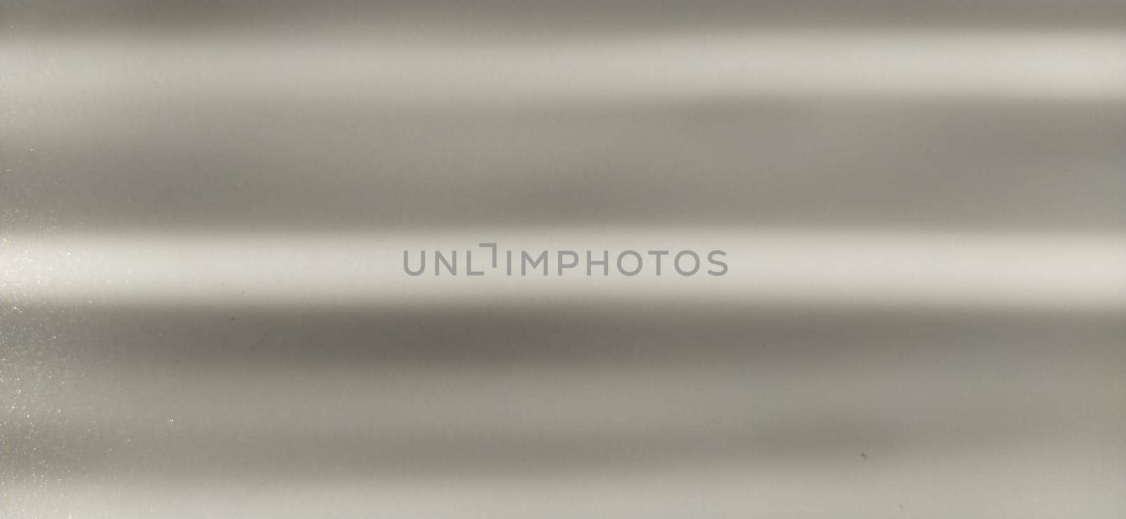 blurred striped gray background. Play of light and shadow. Light beams. Gray and silver shades with white dots and shining stars