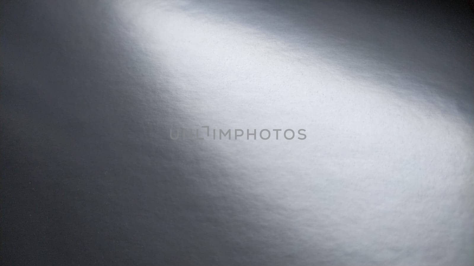 Gradient on a gray background. Glossy paper or foil folded horizontally with overflow and highlights. Soft corner light. A mysterious glow. Metallic silver luster. Banner.
