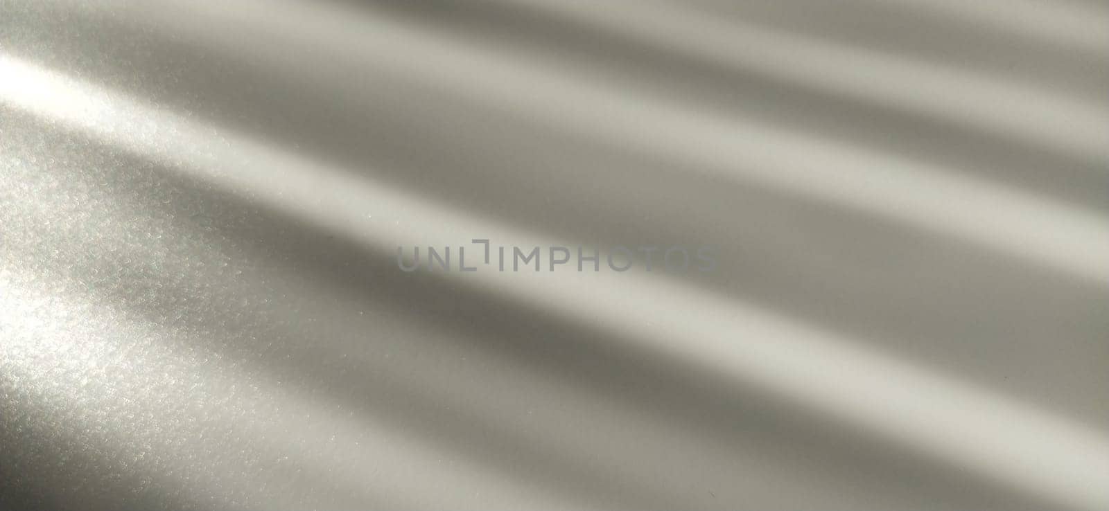 Gray striped background with oblique light effect. Play of light and shadow. Light rays. Gray and silver shades with white dots and shining stars. Diagonal lines from left to right.
