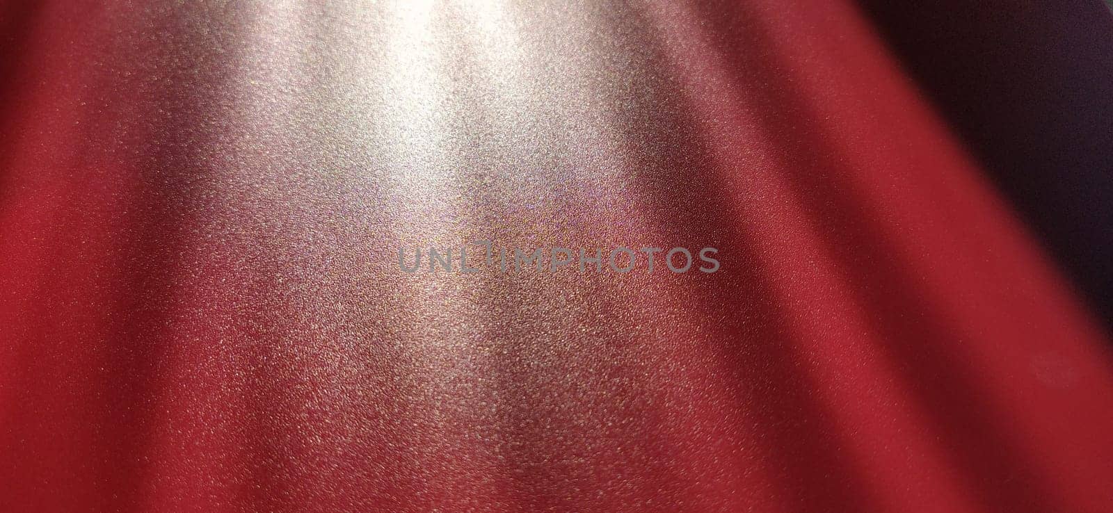 blurred striped red background. Play of light and shadow. Light rays. Divine or heavenly radiance from above. Simulate lighting something from above with spotlights. Copy space