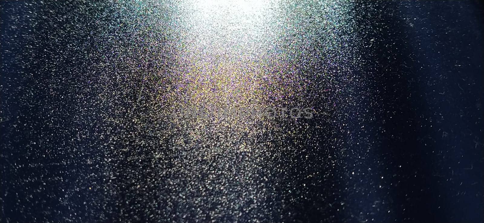 blurred striped dark black and blue background. Play of light and shadow. Light rays. Divine or heavenly radiance from above. Simulate lighting something from above with spotlights. Copy space.