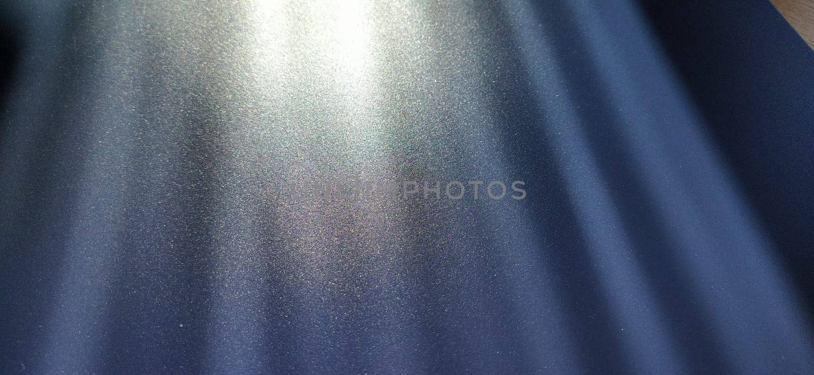 blurred striped dark black and blue background. Play of light and shadow. Light rays. Divine or heavenly radiance from above. Simulate lighting something from above with spotlights. Copy space.