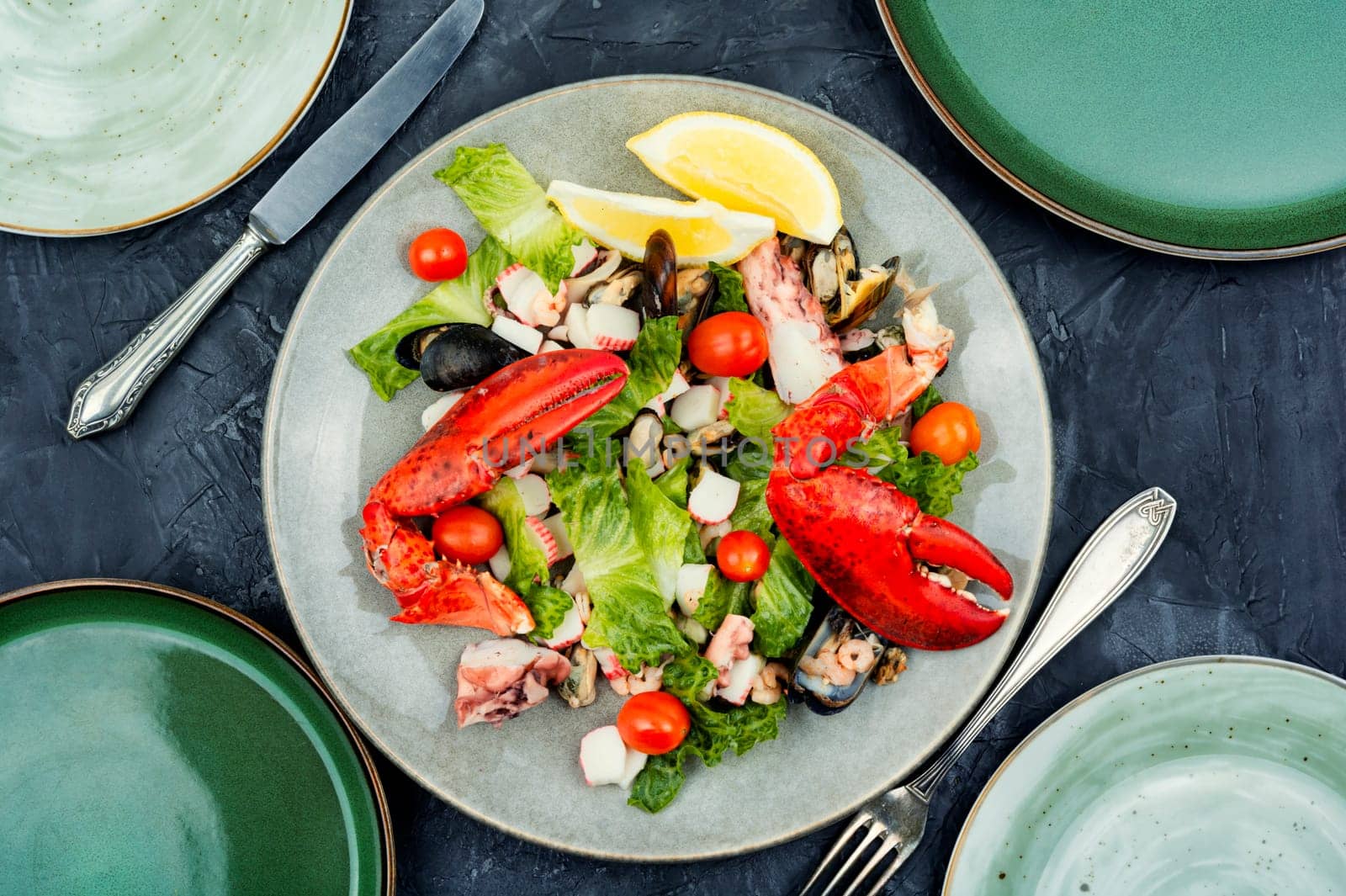 Appetizing salad of oysters, mussels, lobster and vegetables. Ketogenic