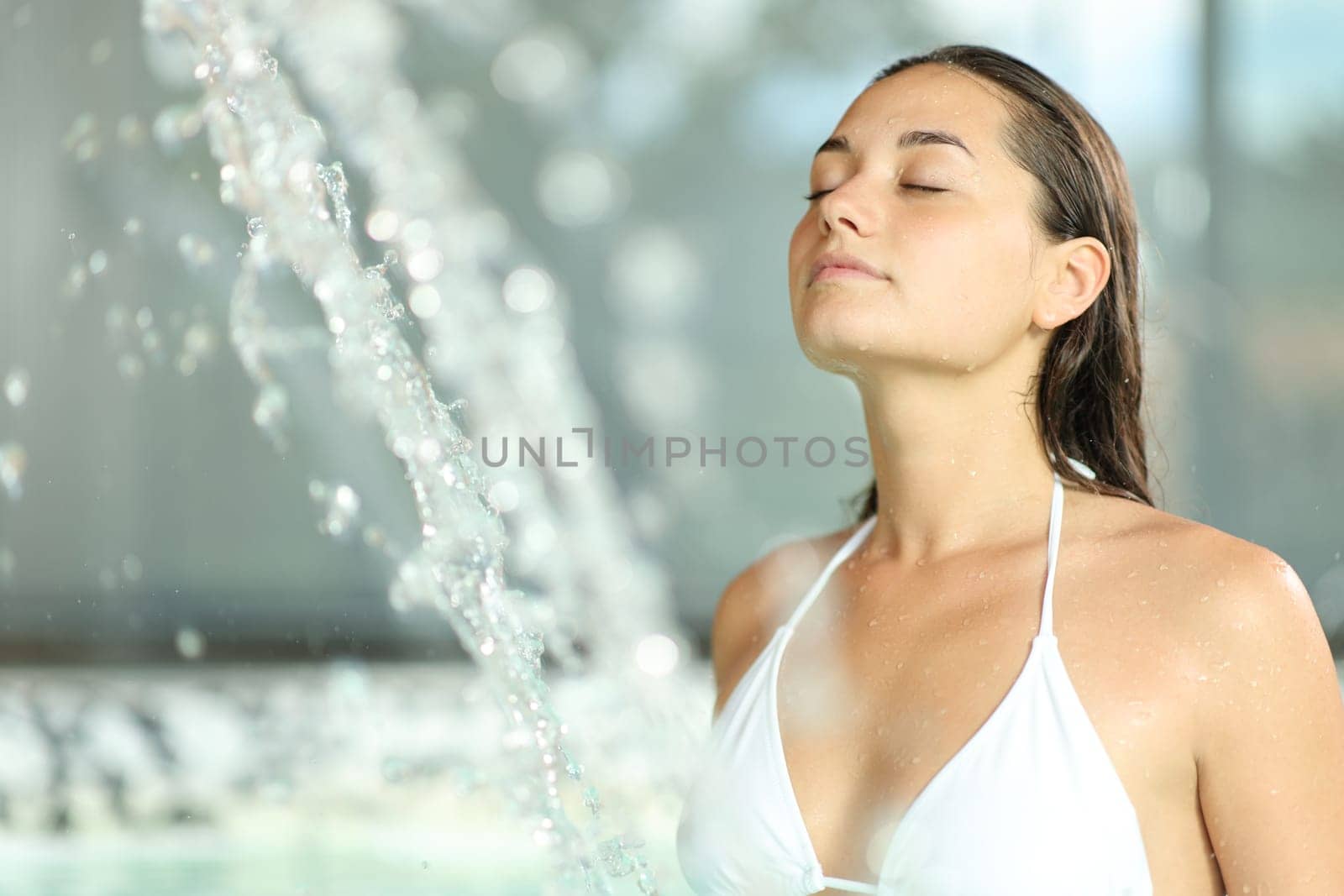 Beautiful woman relaxing and breathing in spa pool