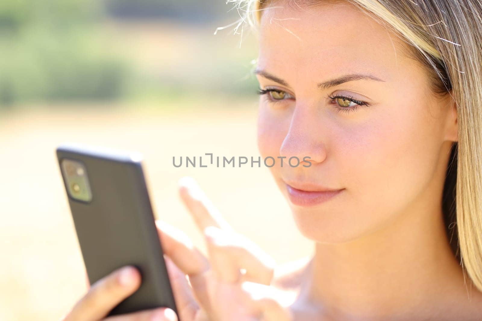 Woman using smart phone in nature