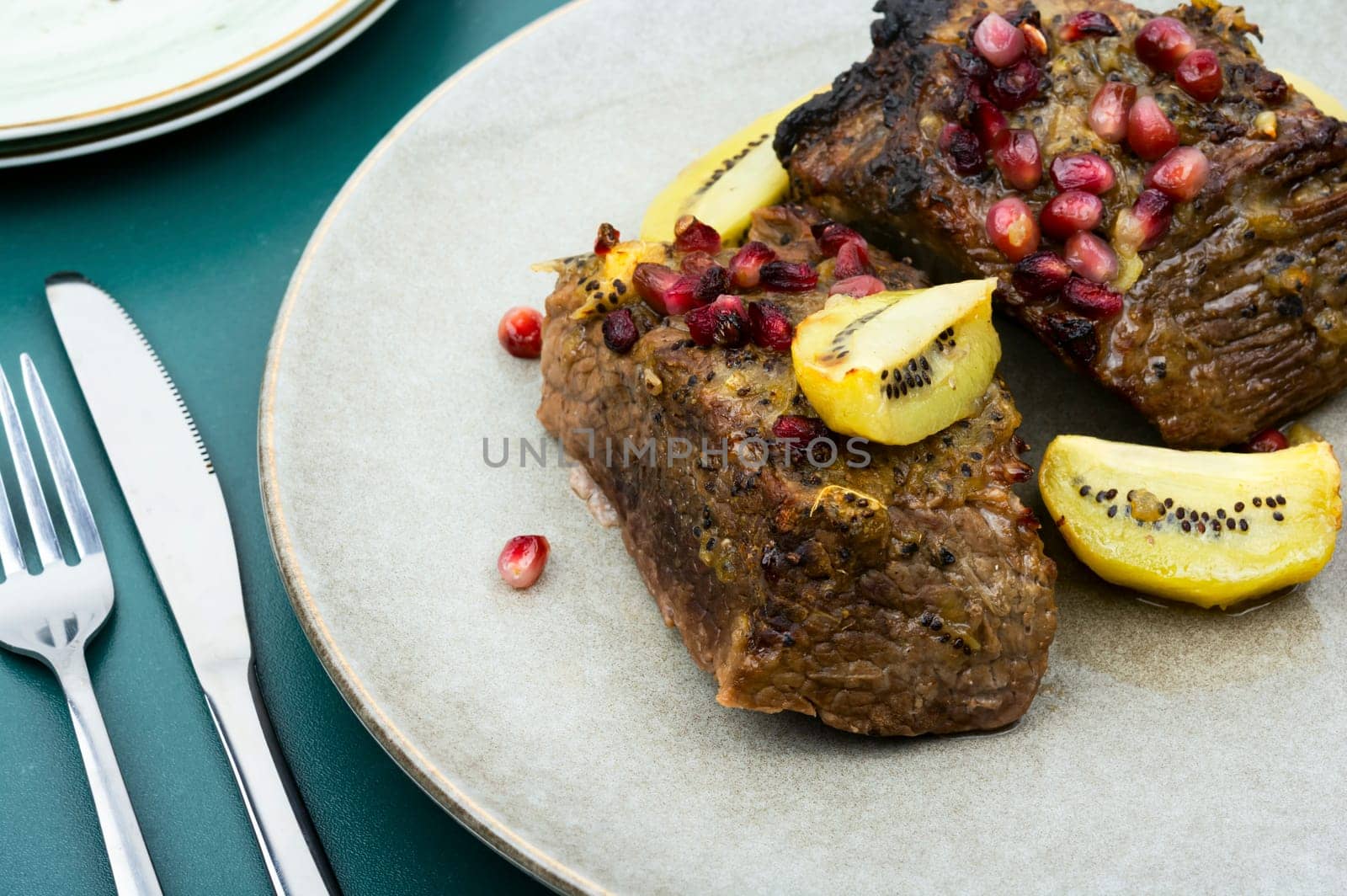 Veal meat roasted in fruit sauce. Top view