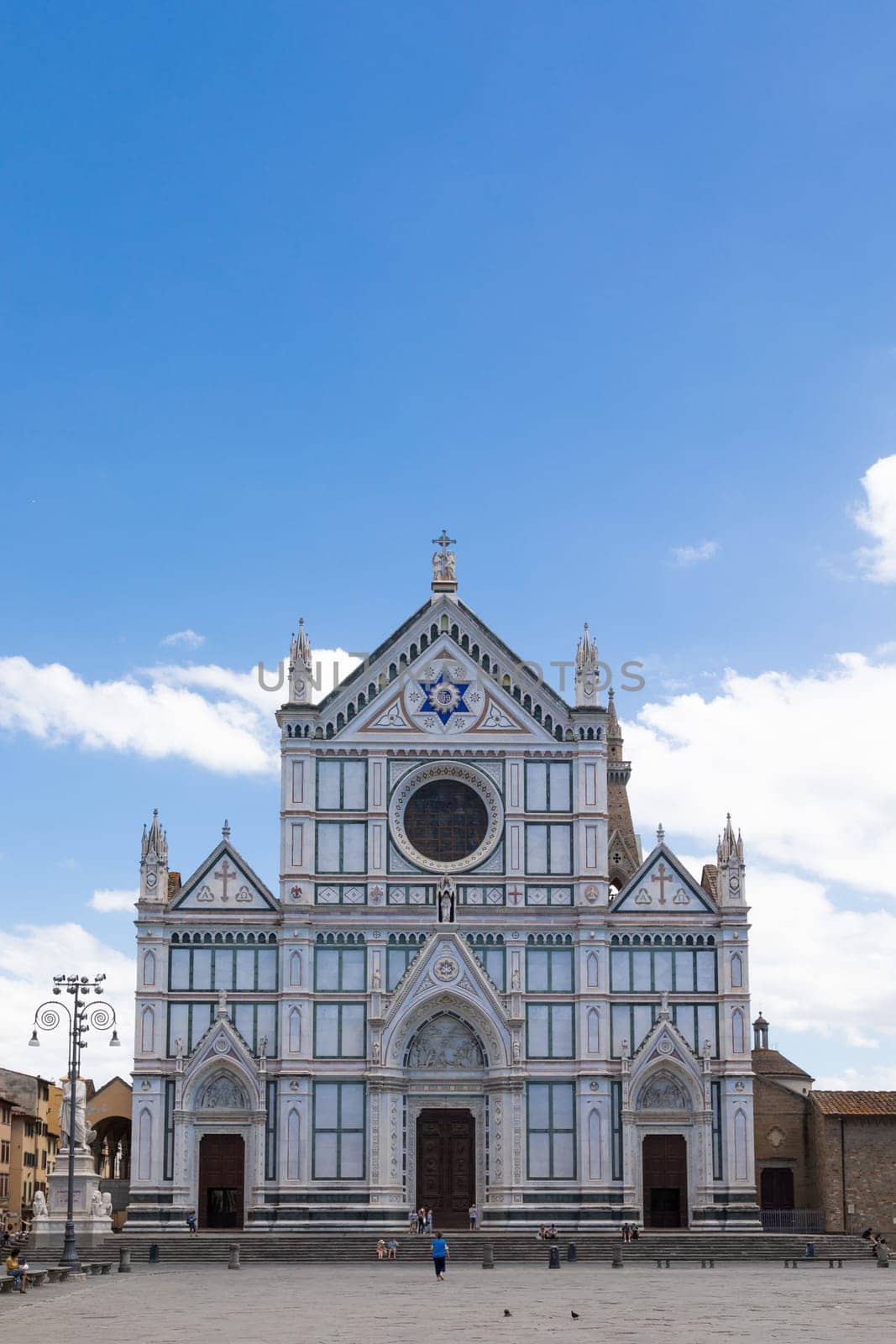 Florence, Italy - June 2022: Basilica of Santa Croce, blue sky and clouds