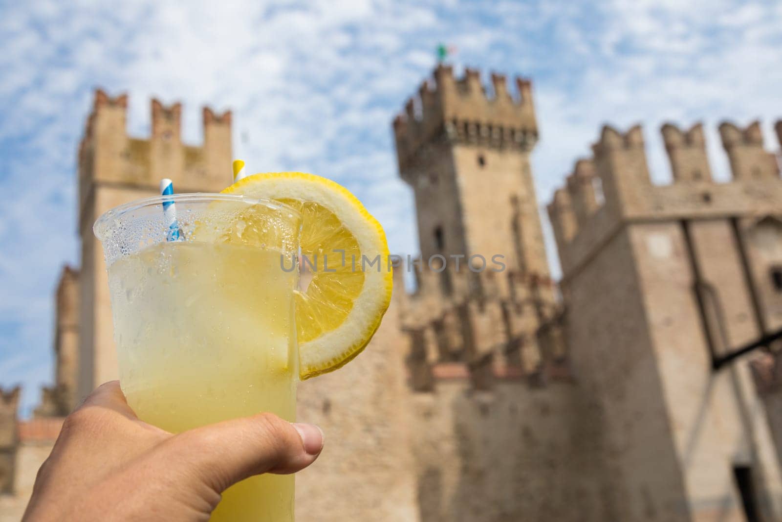 Hand with fresh cold lemonade. Concept for enjoy, relaxation, travel, summer