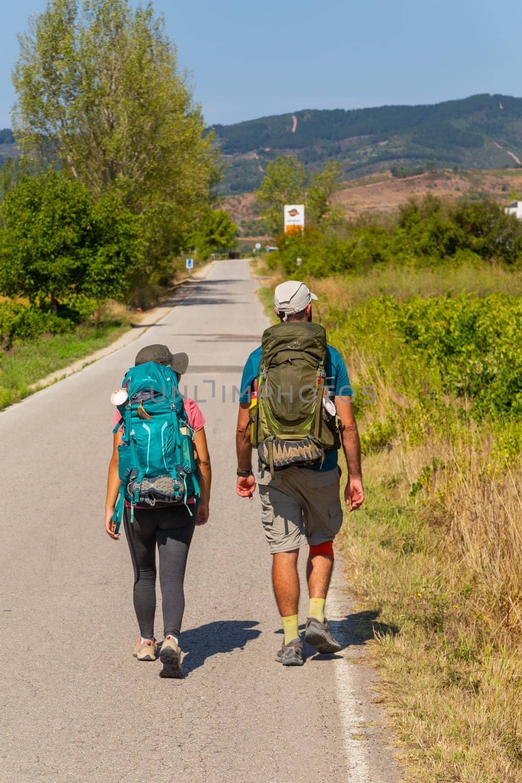 Navarre, Spain, 26 August, 2022: Pilgrims walk along the Camino De Santiago, the Way of St. James pilgrimage route, Navarra, Spain.