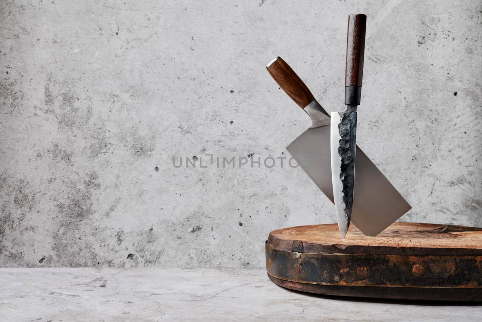 Knive and cleaver sticking out of wooden stump