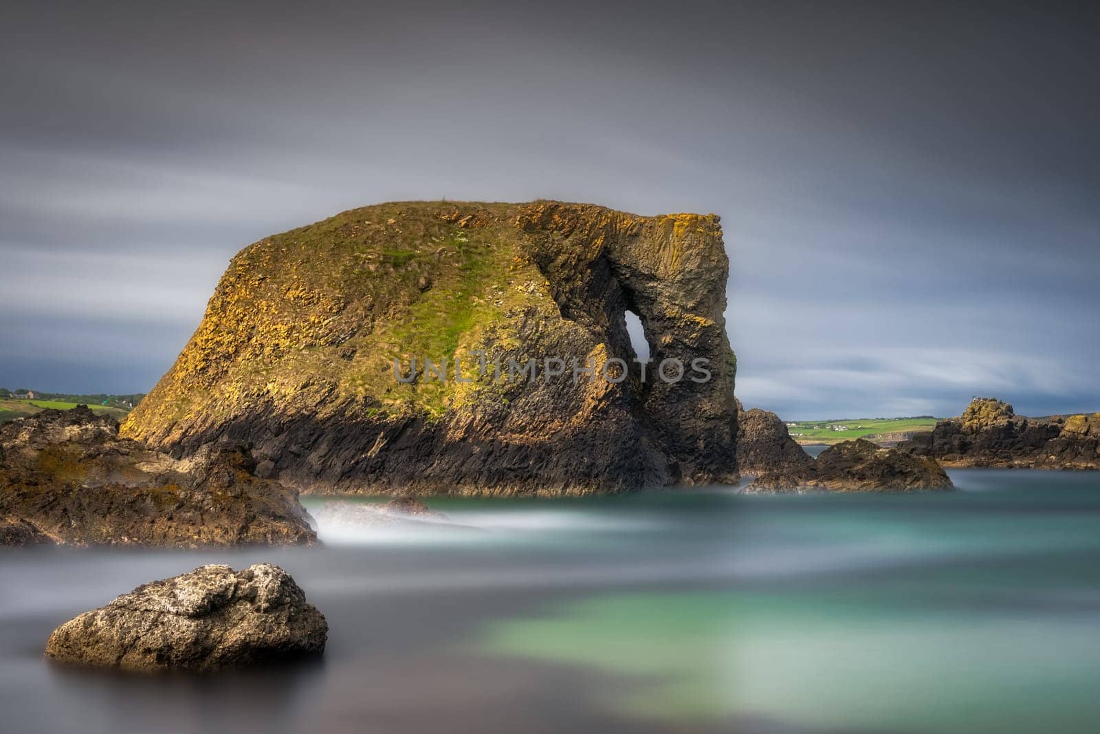 Beautiful costal rock formation, Elephant Rock on long exposure with blurred water and sky, Wild Atlantic Way in Country Antrim, Northern Ireland