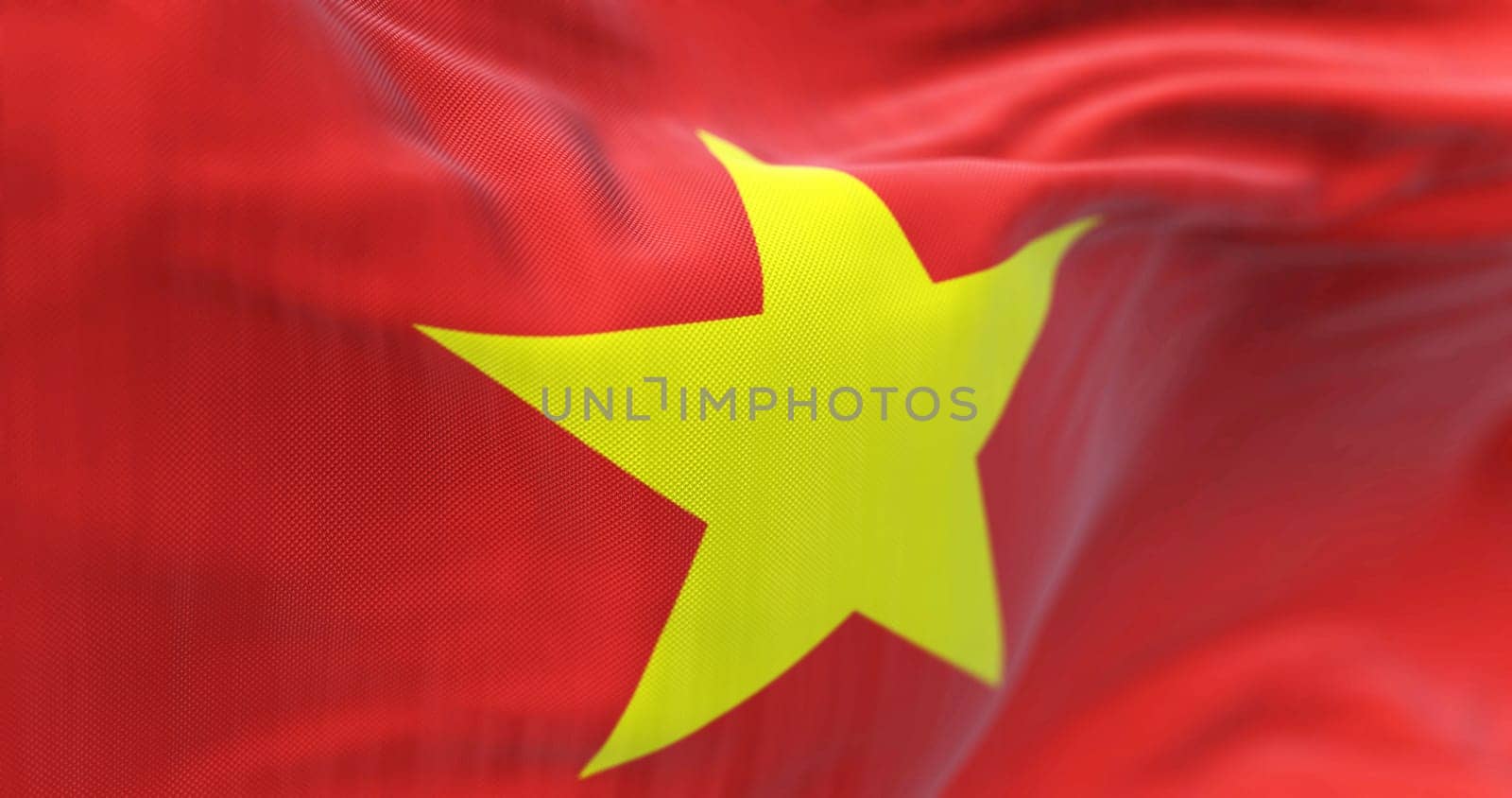 Detail of the Vietnam national flag waving in the wind. Red flag with a large yellow five-pointed star in the center. 3d illustration render. Selective focus. Close-up. Textured fabric background