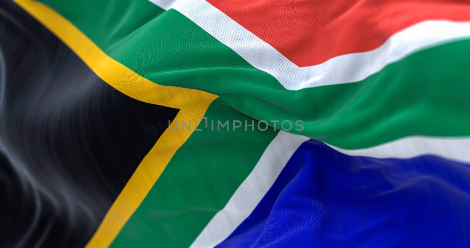 Detail of the South Africa flag waving. Red and blue flag divided by a green Y that encloses a black triangle with a yellow border. 3d illustration render. Selective focus. Close-up.