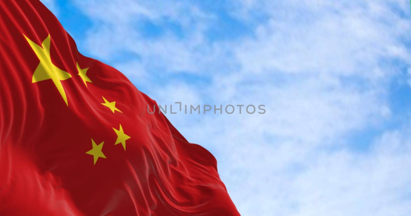 The flag of China waving on a sunny day. Red background, five yellow stars. The largest star symbolizes the guidance of the Chinese Communist Party. 3D illustration render. Rippled fabric